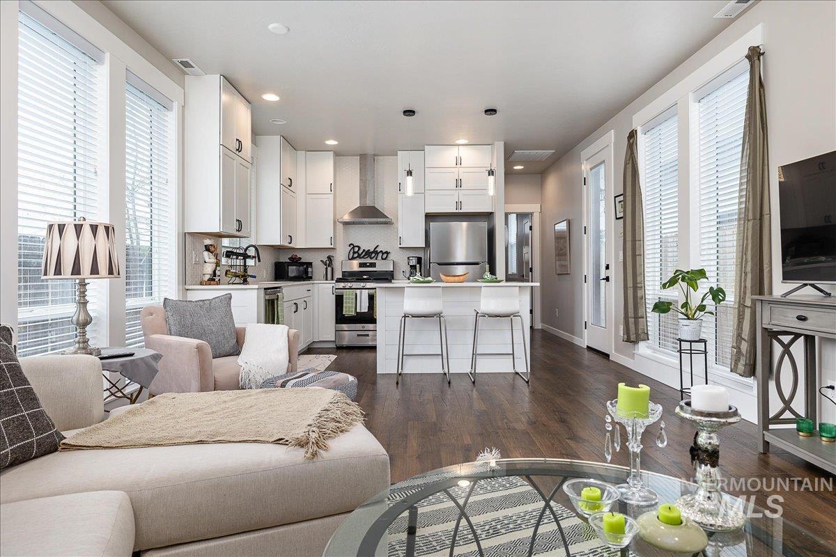 Living room with dark wood-type flooring and recessed lighting