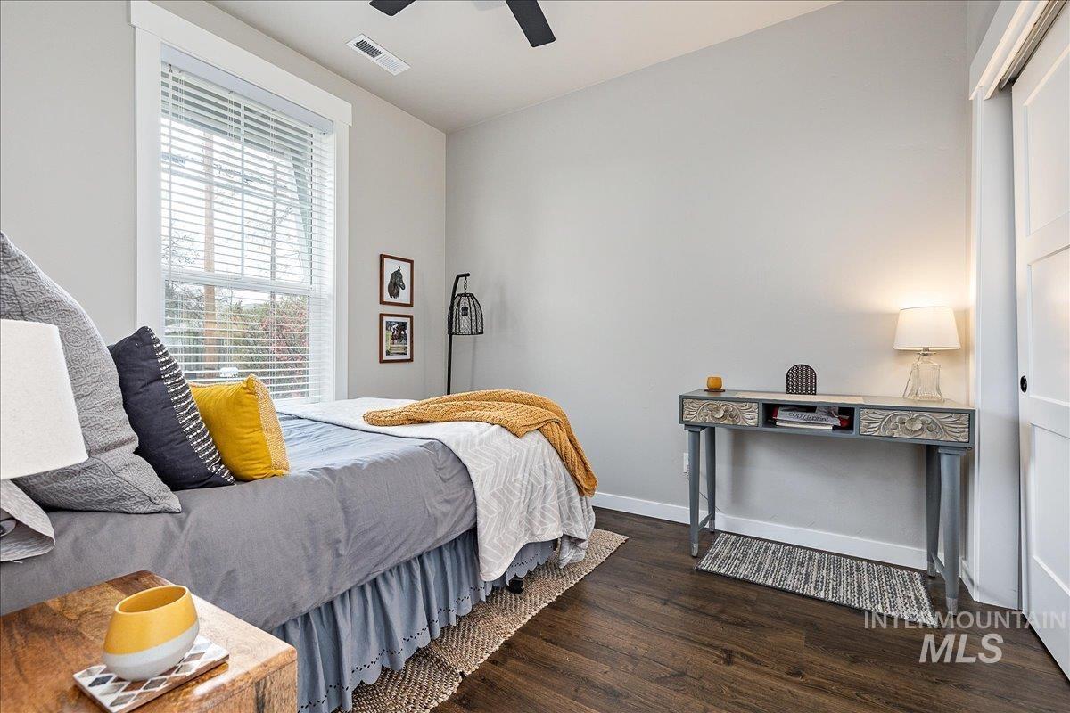 Bedroom featuring dark wood finished floors and a ceiling fan