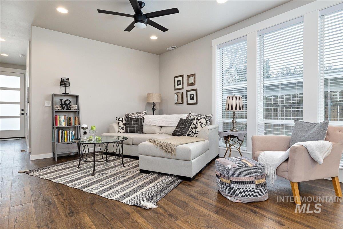 Living area featuring ceiling fan, dark wood finished floors, and recessed lighting