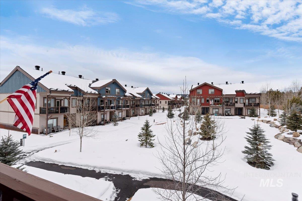 Snowy yard with a residential view