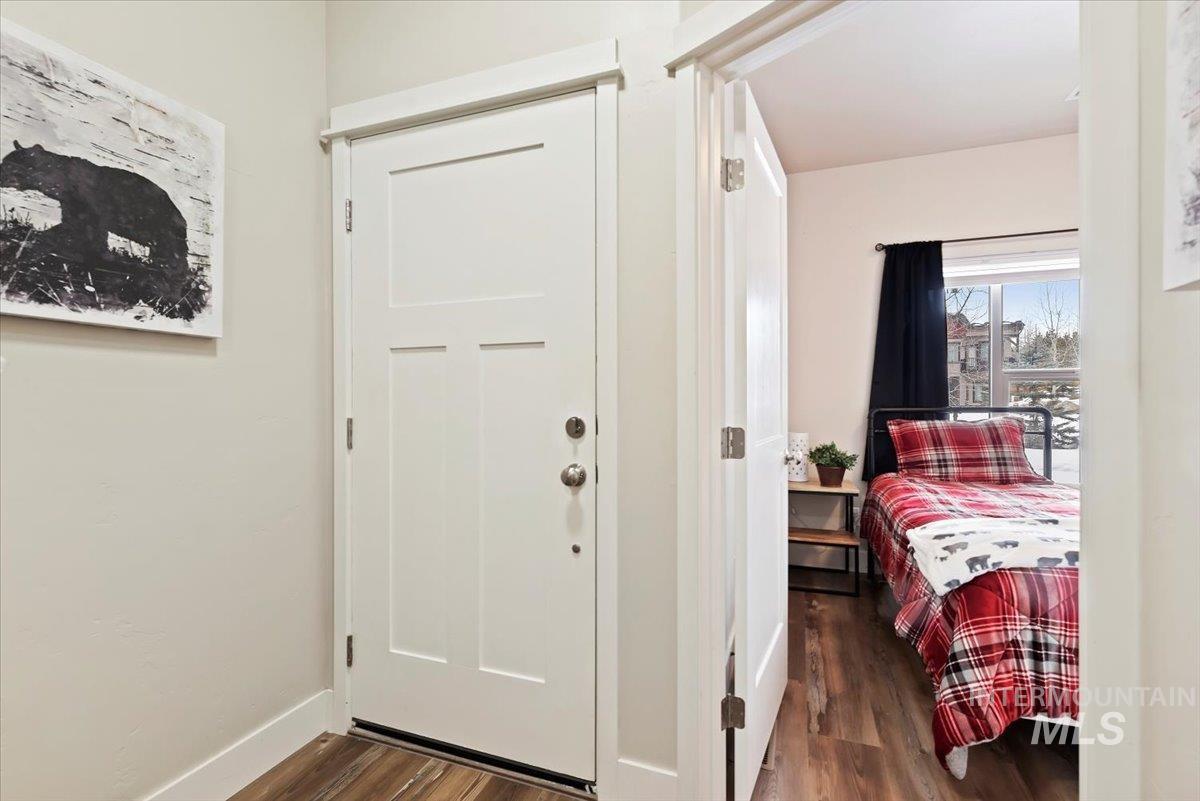 Bedroom with dark wood-style flooring