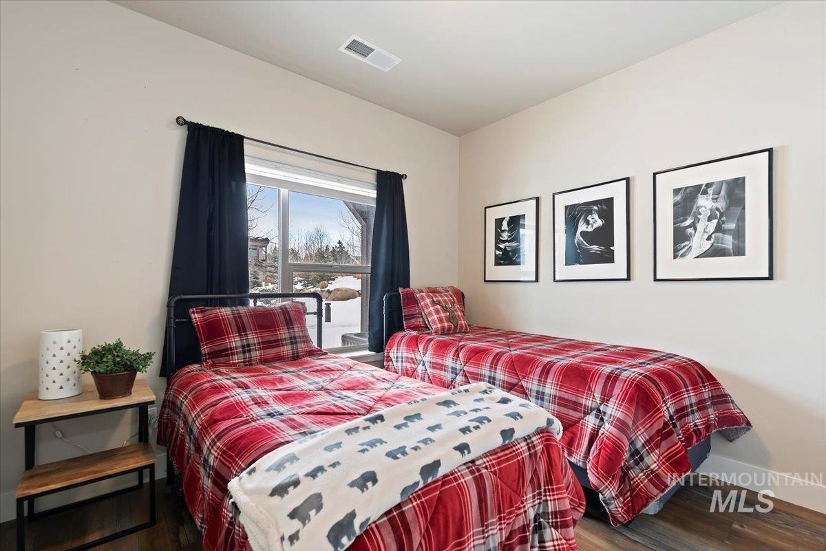 Bedroom with baseboards and wood finished floors
