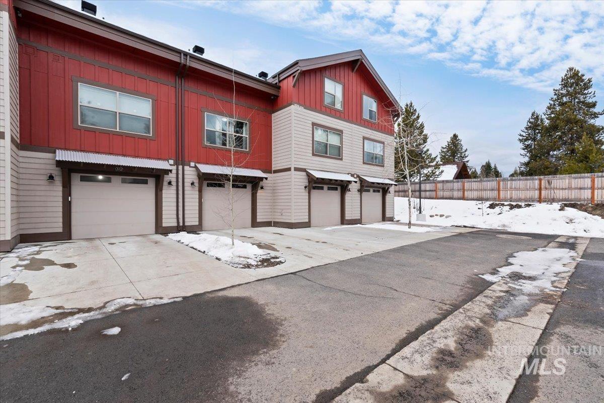 View of home's exterior featuring driveway, a garage, and board and batten siding