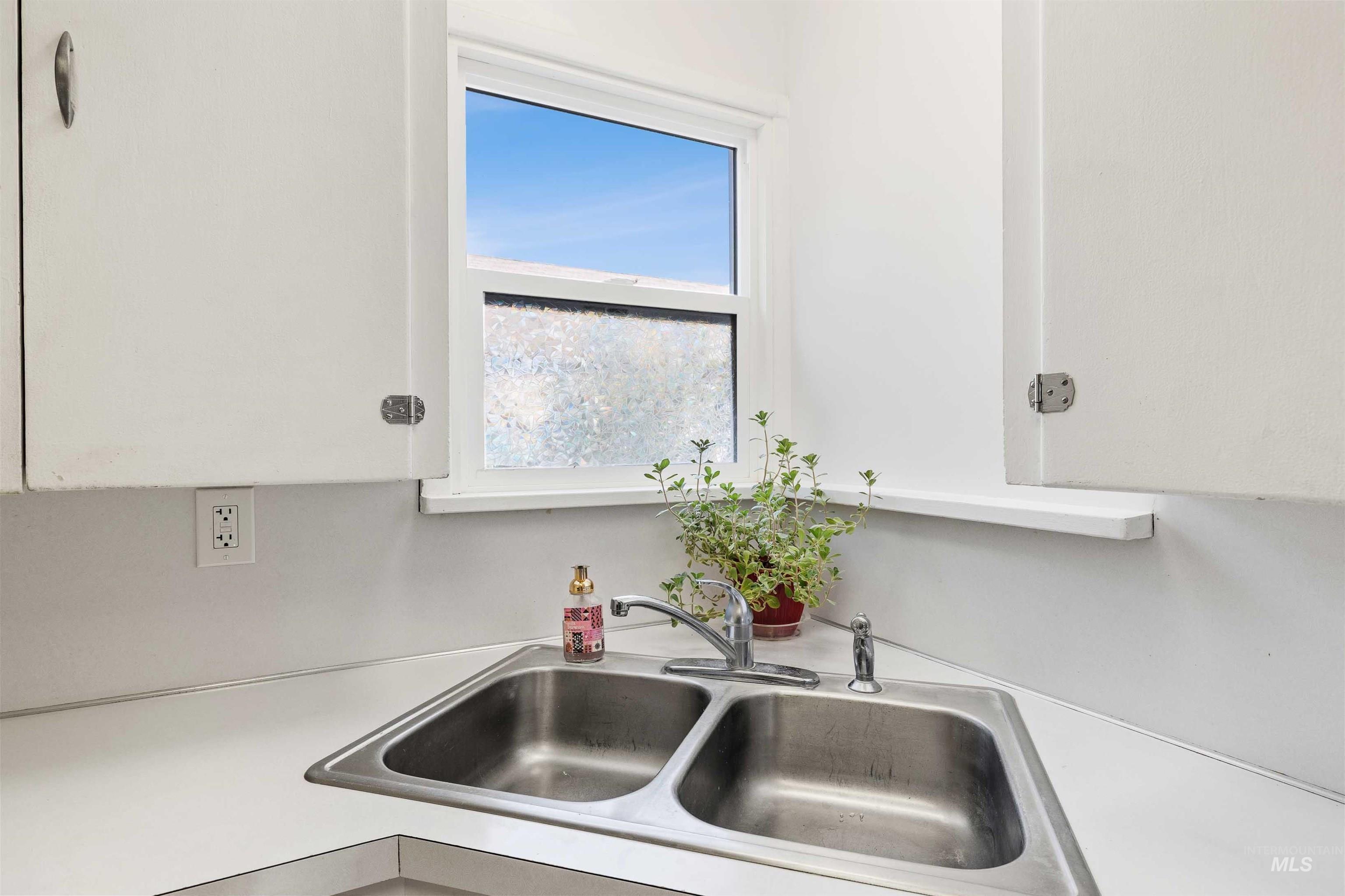 Kitchen with a sink and light countertops