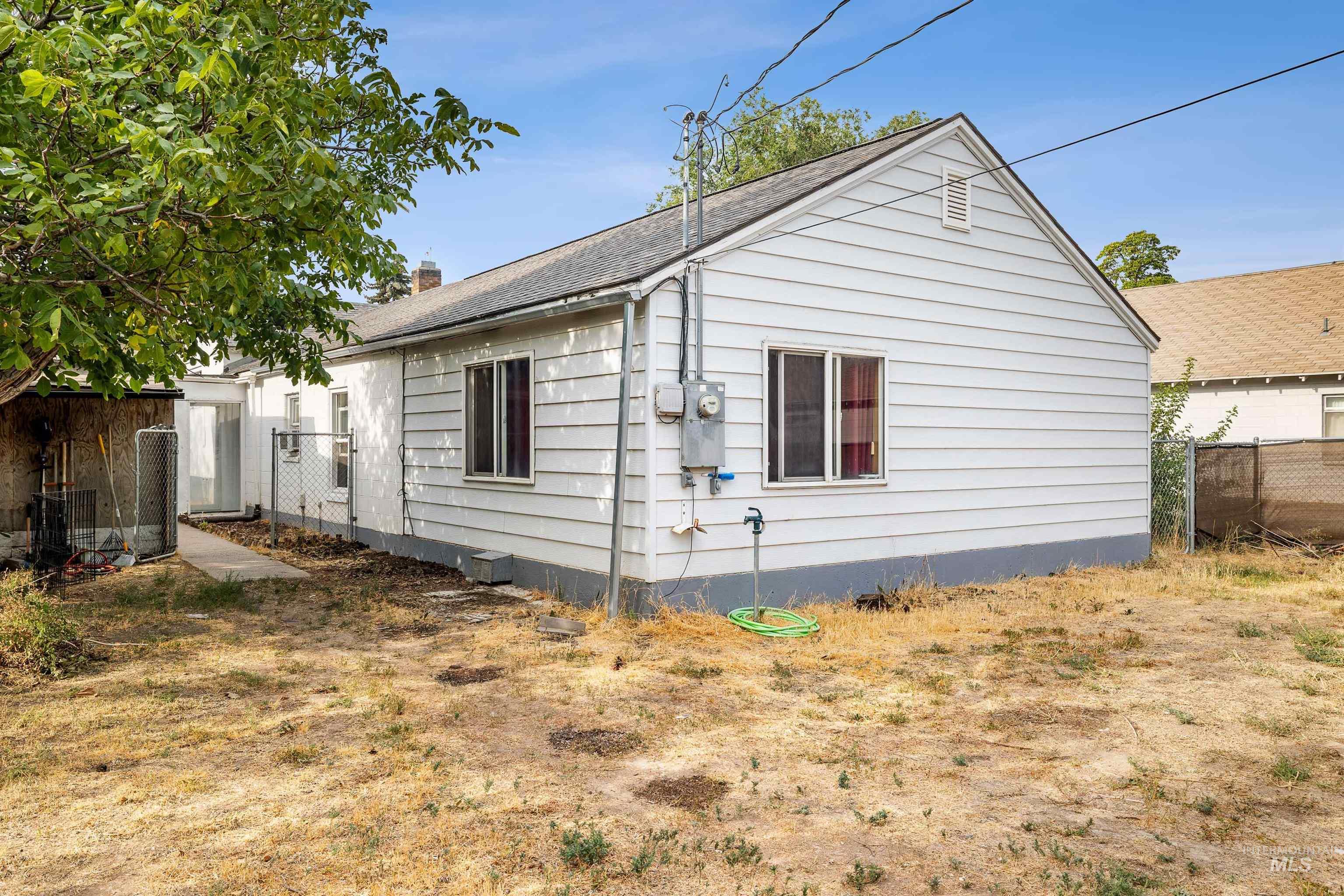 View of side of home featuring a chimney and roof with shingles