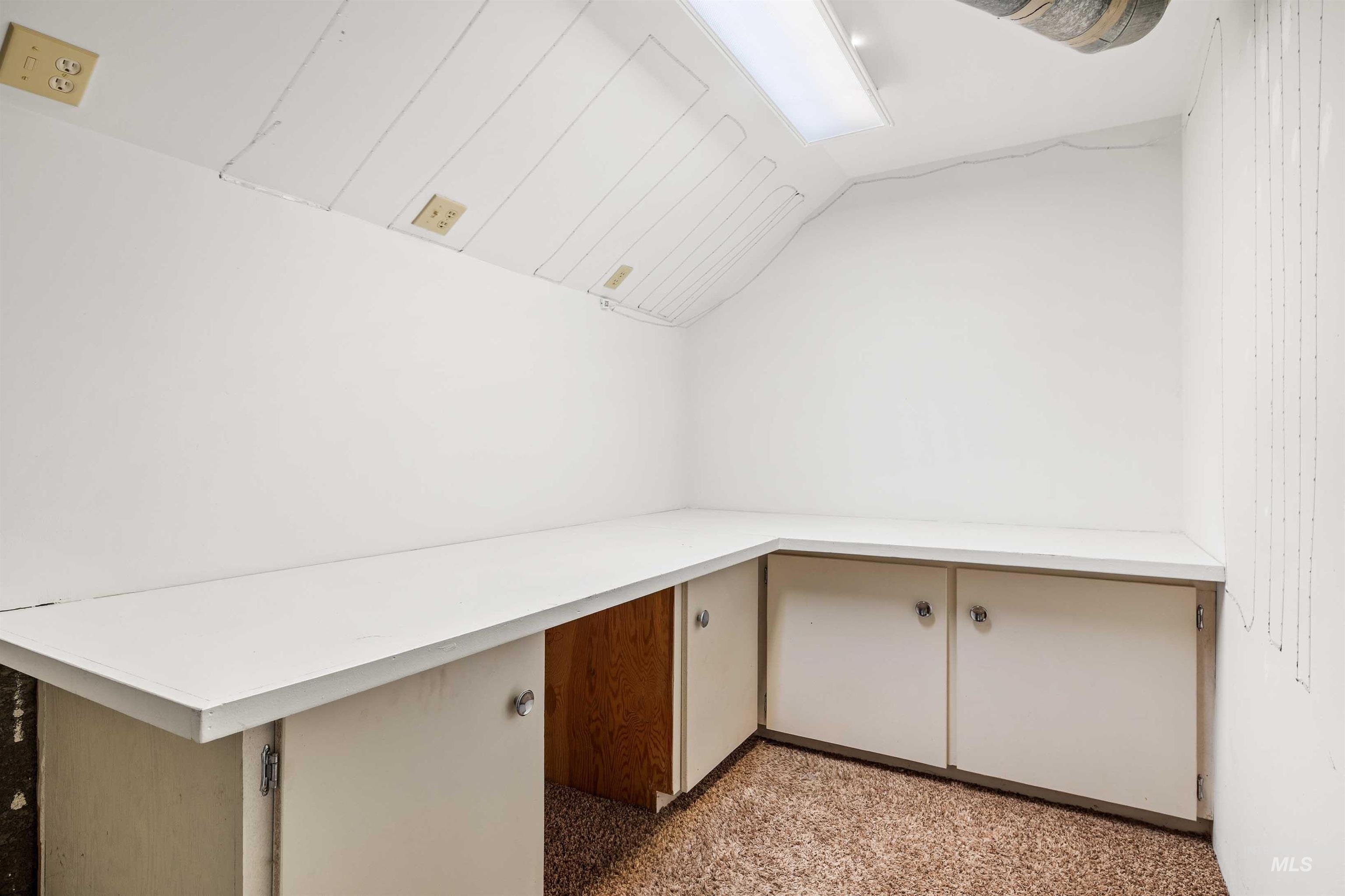 Unfurnished office featuring lofted ceiling