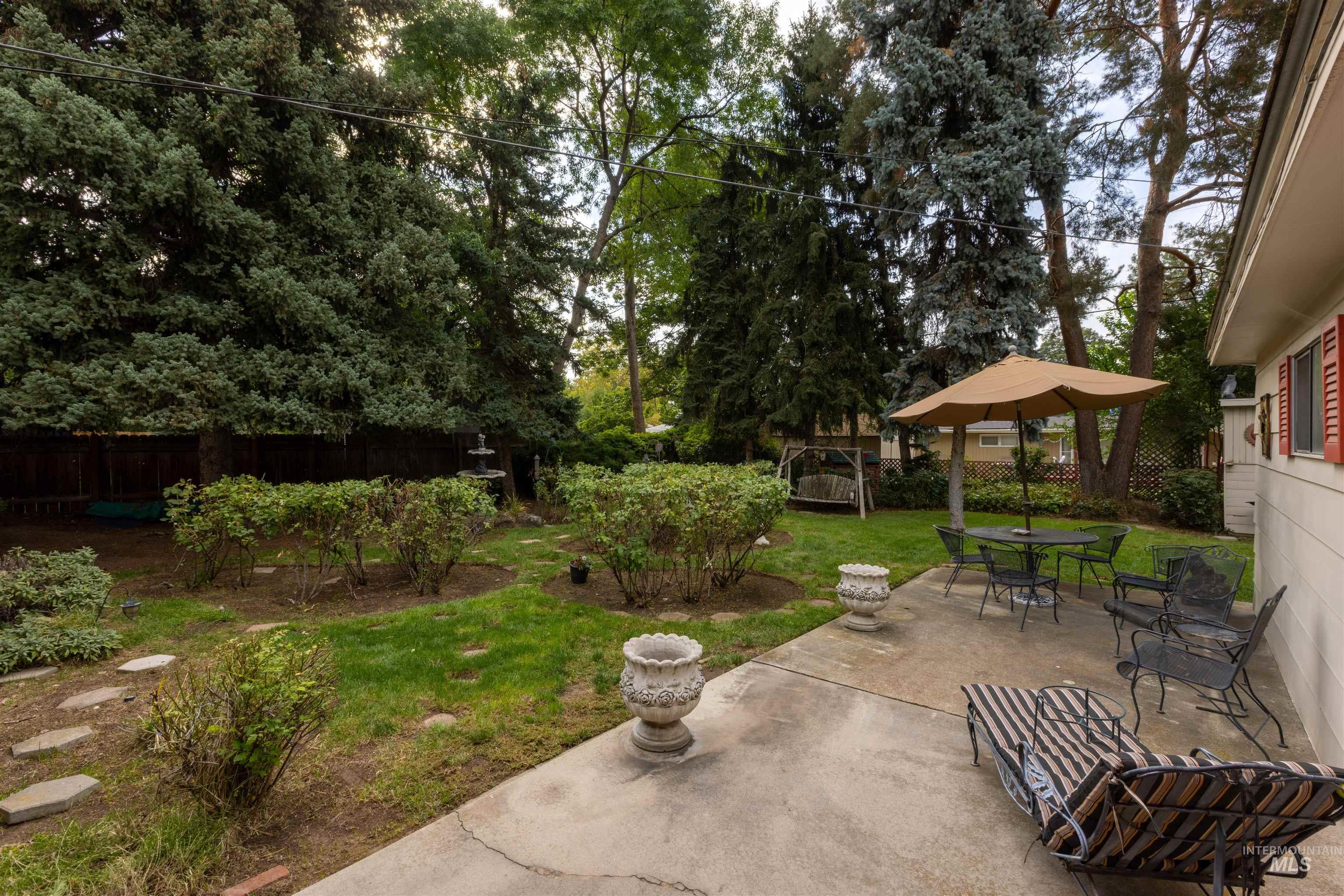 Fenced backyard with a patio and outdoor dining space