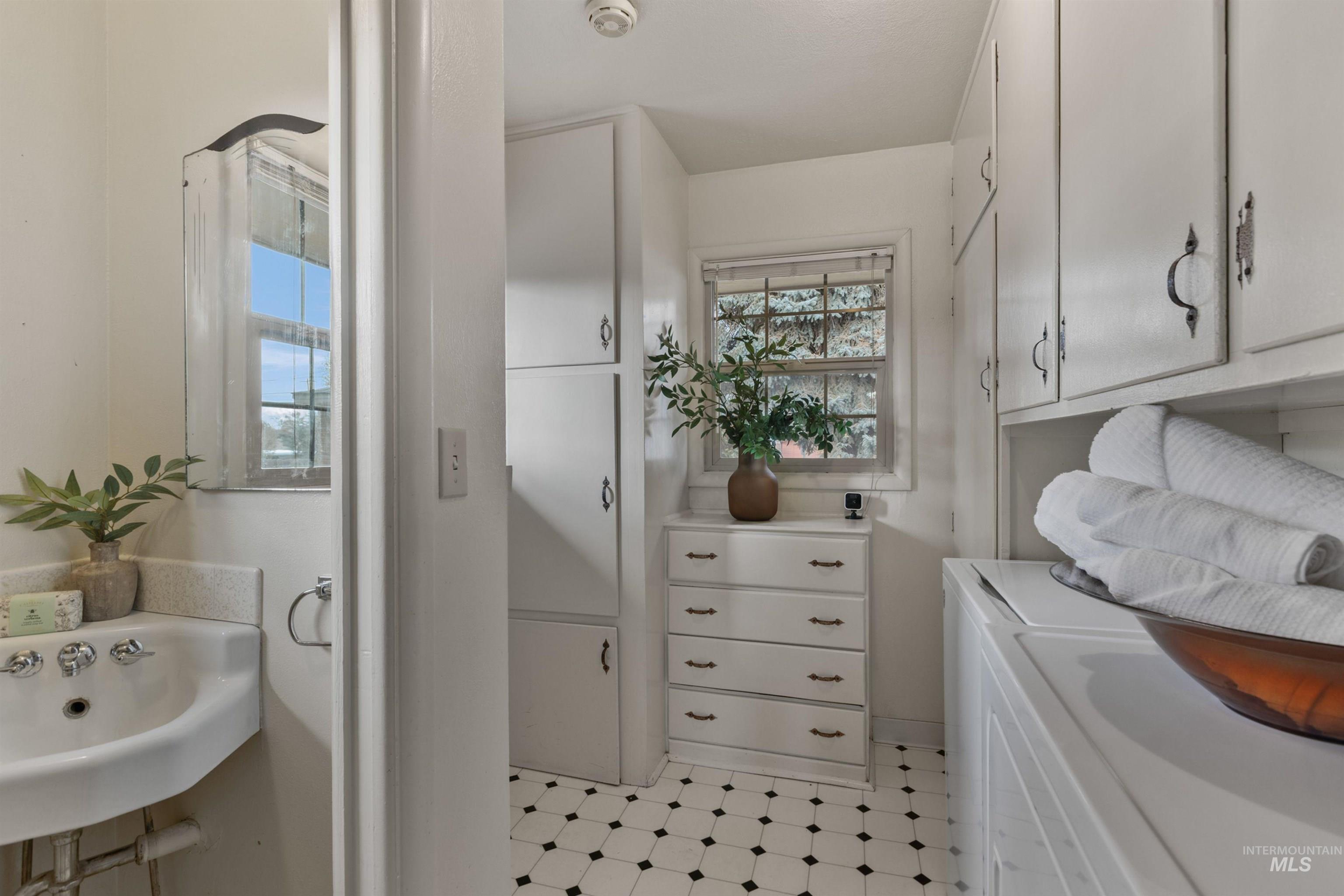 Laundry room featuring cabinet space