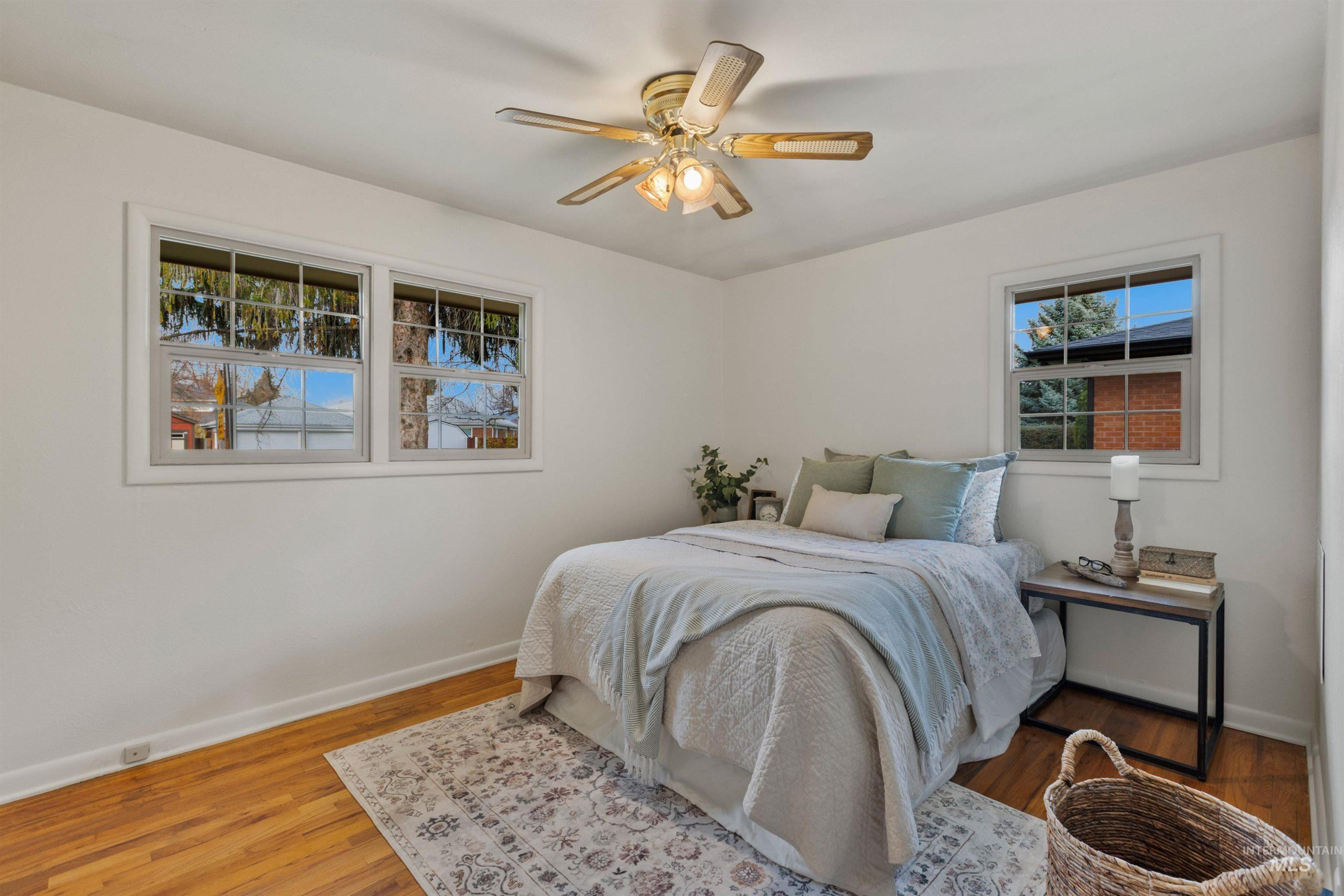 Bedroom with wood finished floors and a ceiling fan