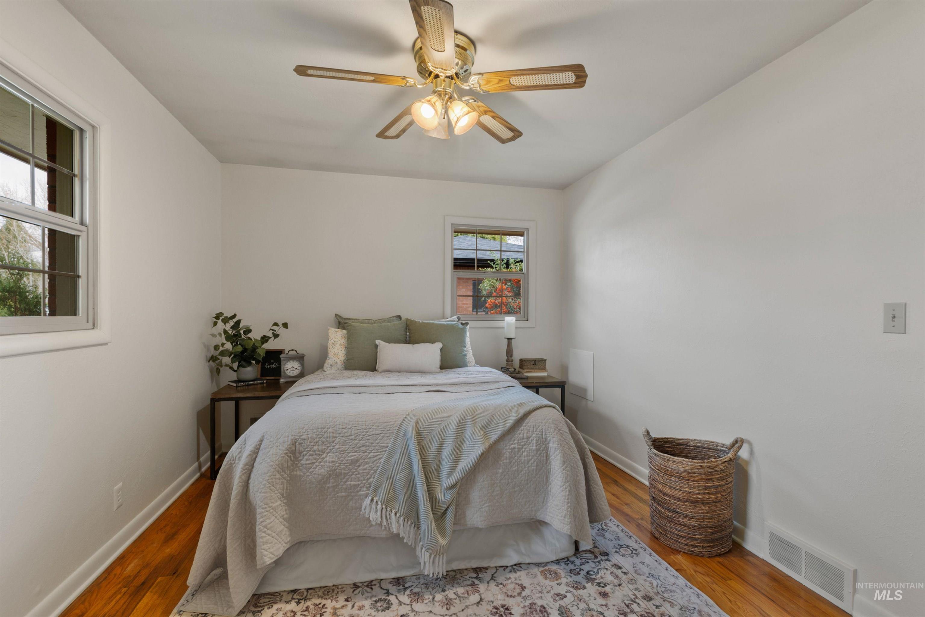 Bedroom with wood finished floors and ceiling fan