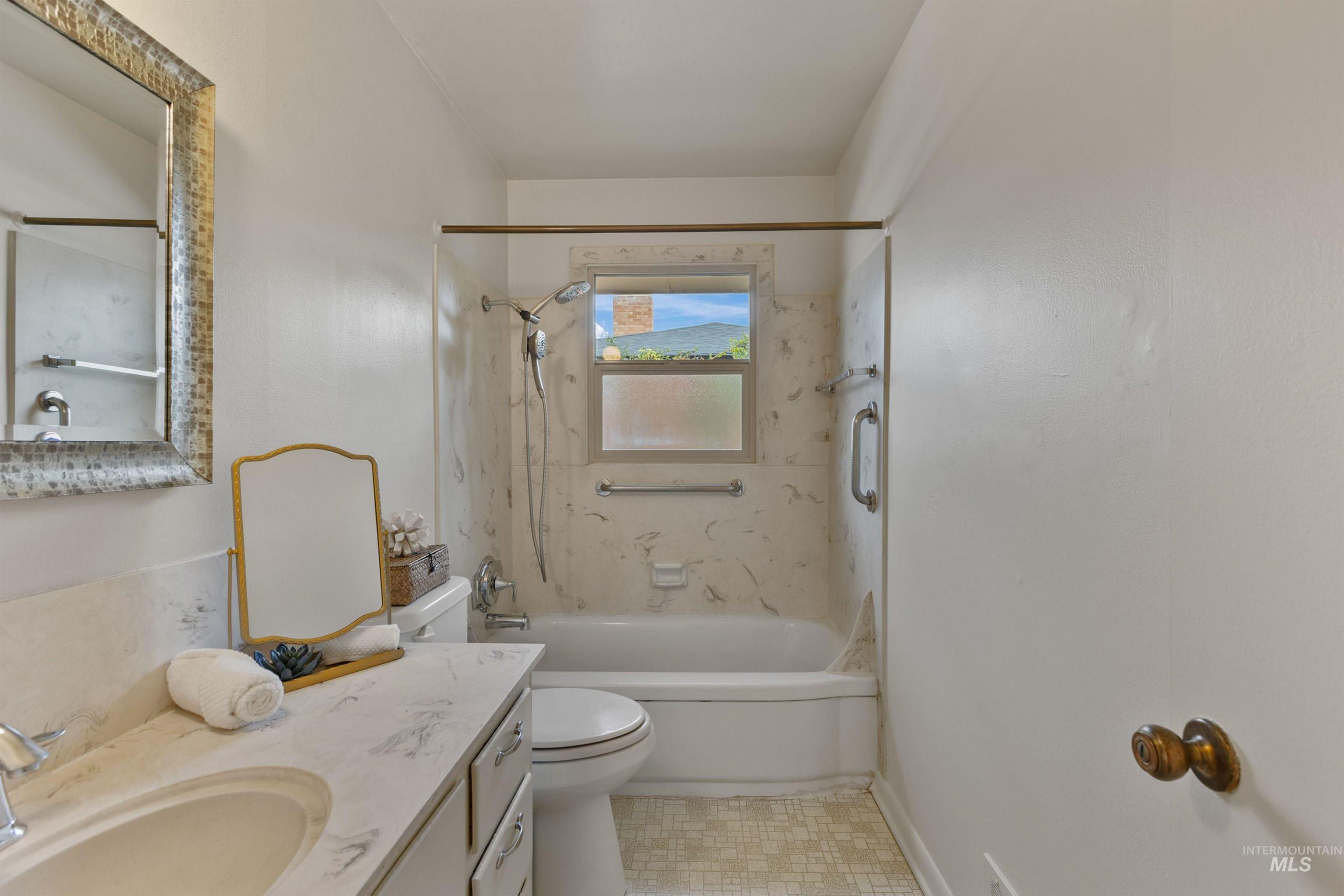Bathroom with vanity and shower / tub combination