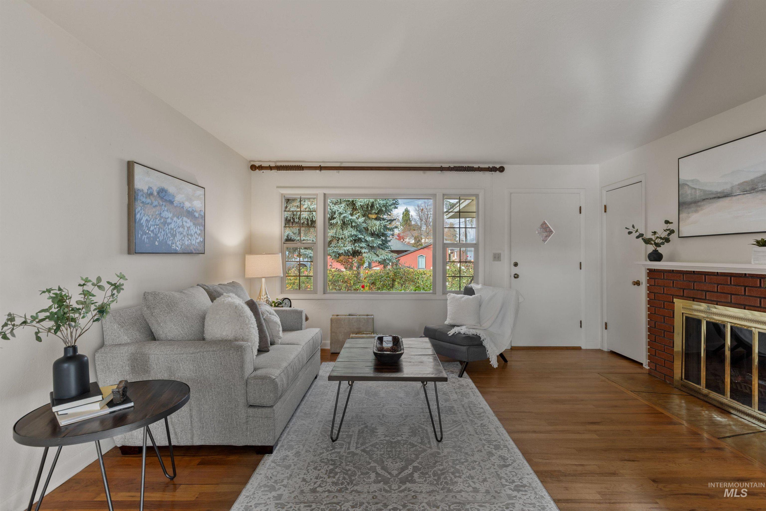 Living area with dark wood-style floors and a fireplace