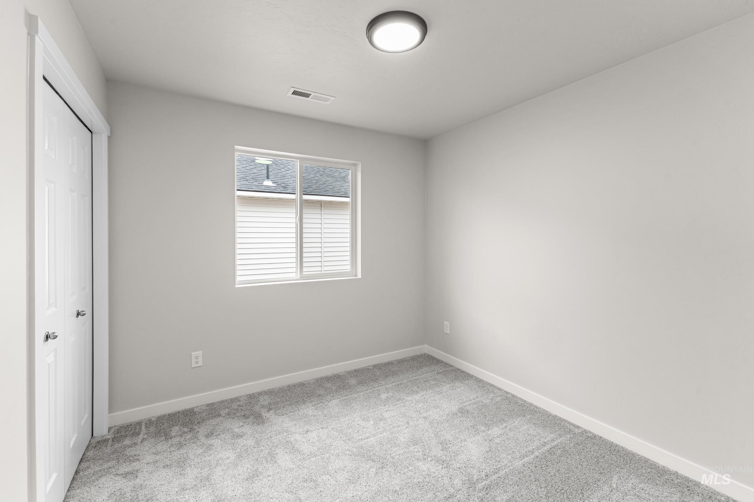 Light gray wall paint complemented by white trim and a neutral carpet