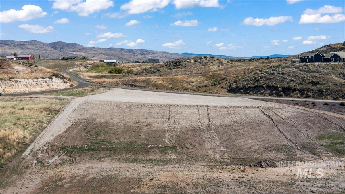 View of dirt / gravel road featuring a mountain view