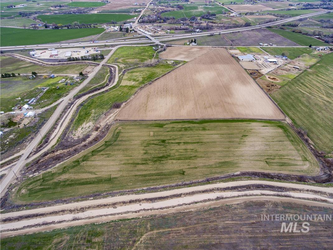 Aerial view of property's location with rural landscape and rows of crops