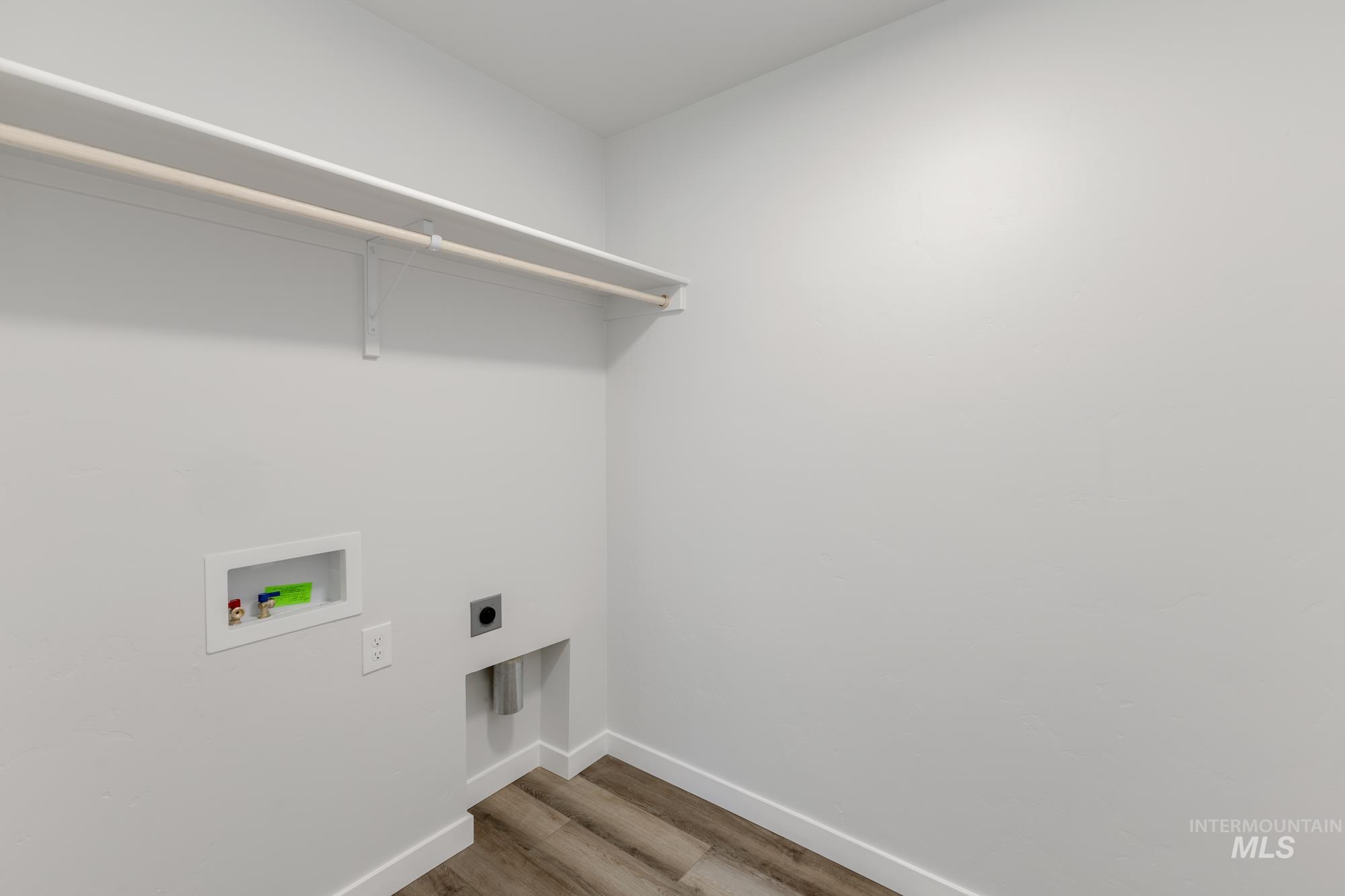 Laundry area featuring hookup for an electric dryer, light wood-type flooring, and hookup for a washing machine