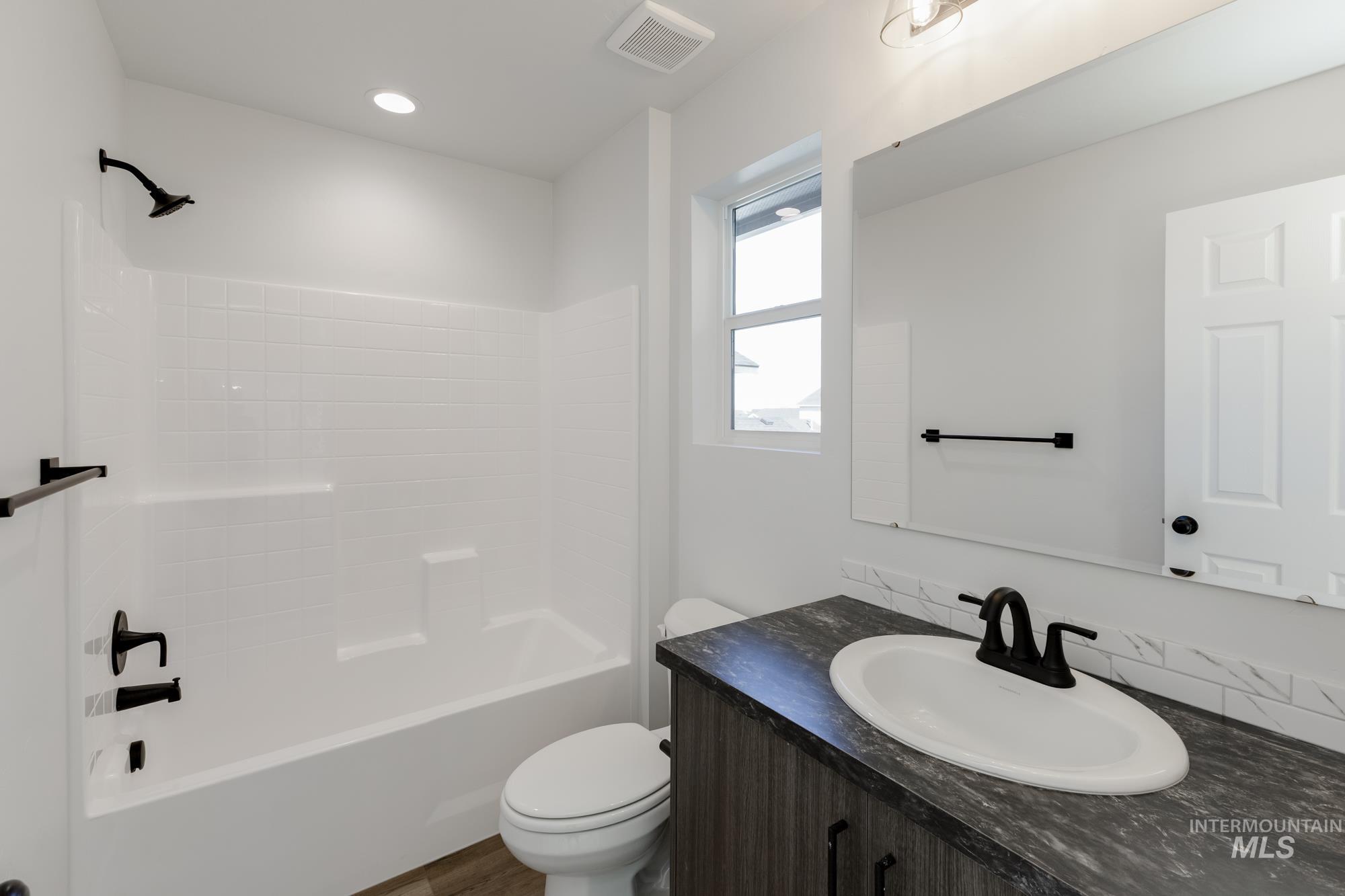 Full bath featuring  shower combination and vanity