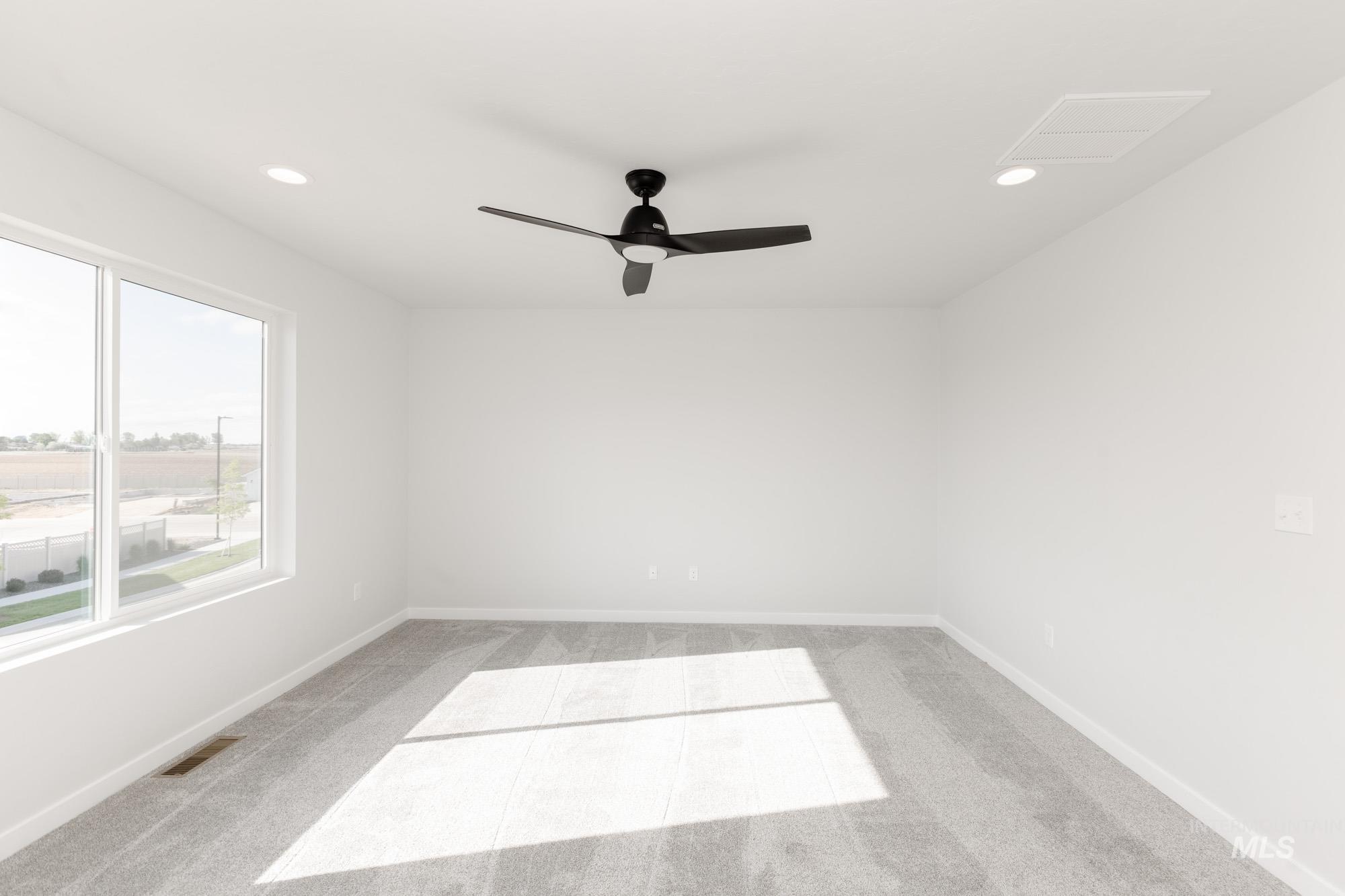 Empty room featuring light carpet, recessed lighting, and a ceiling fan