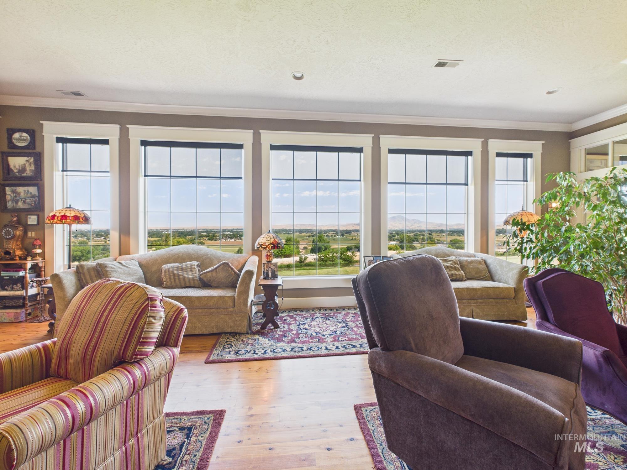 Living room featuring crown molding and hardwood / wood-style floors