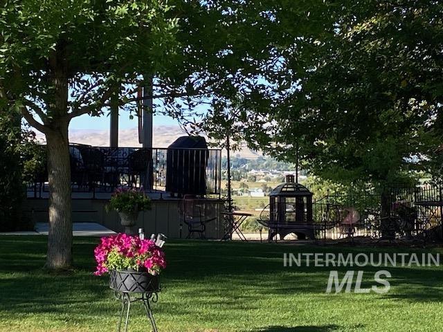 View of property's community with a lawn