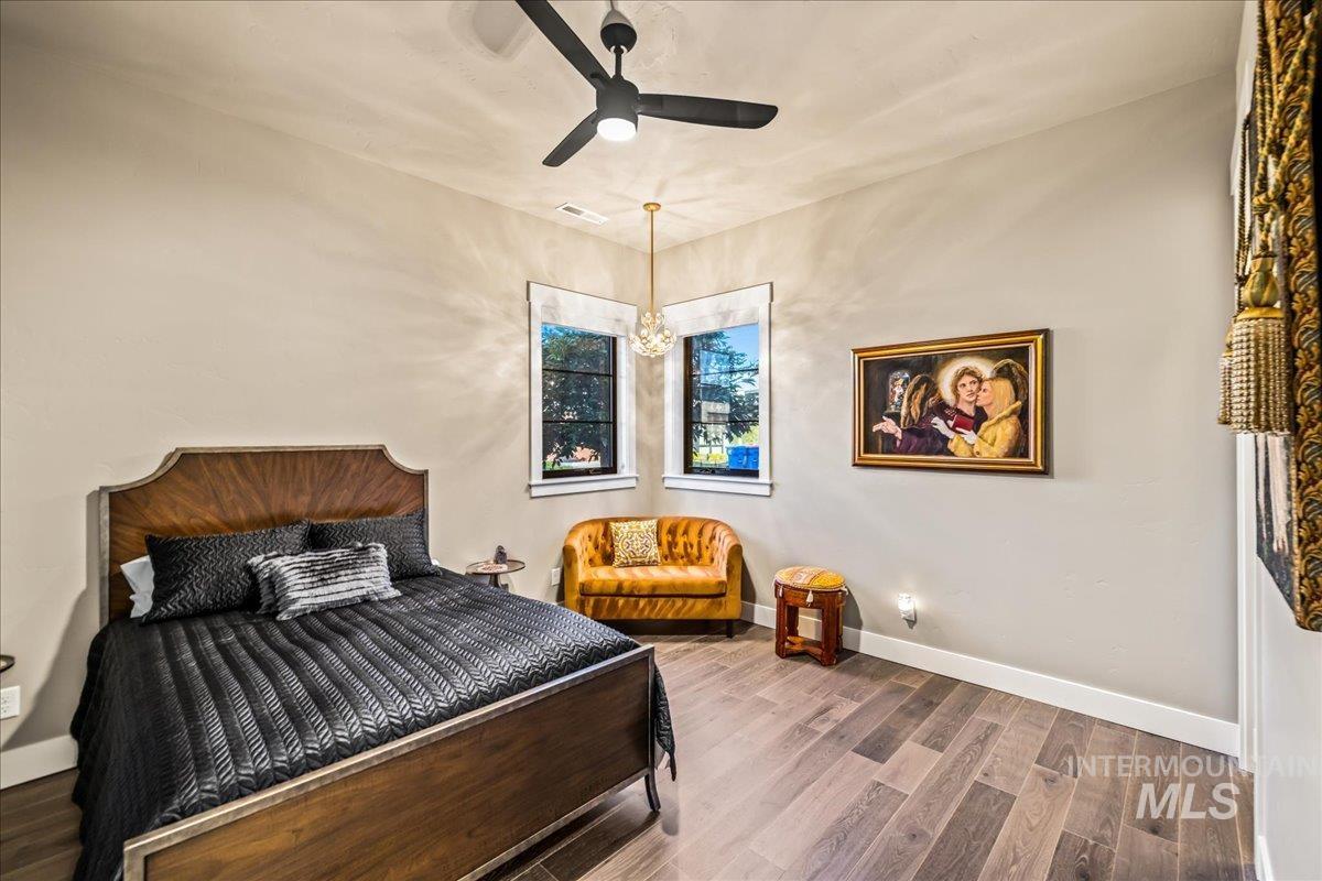 Bedroom with wood finished floors and a ceiling fan