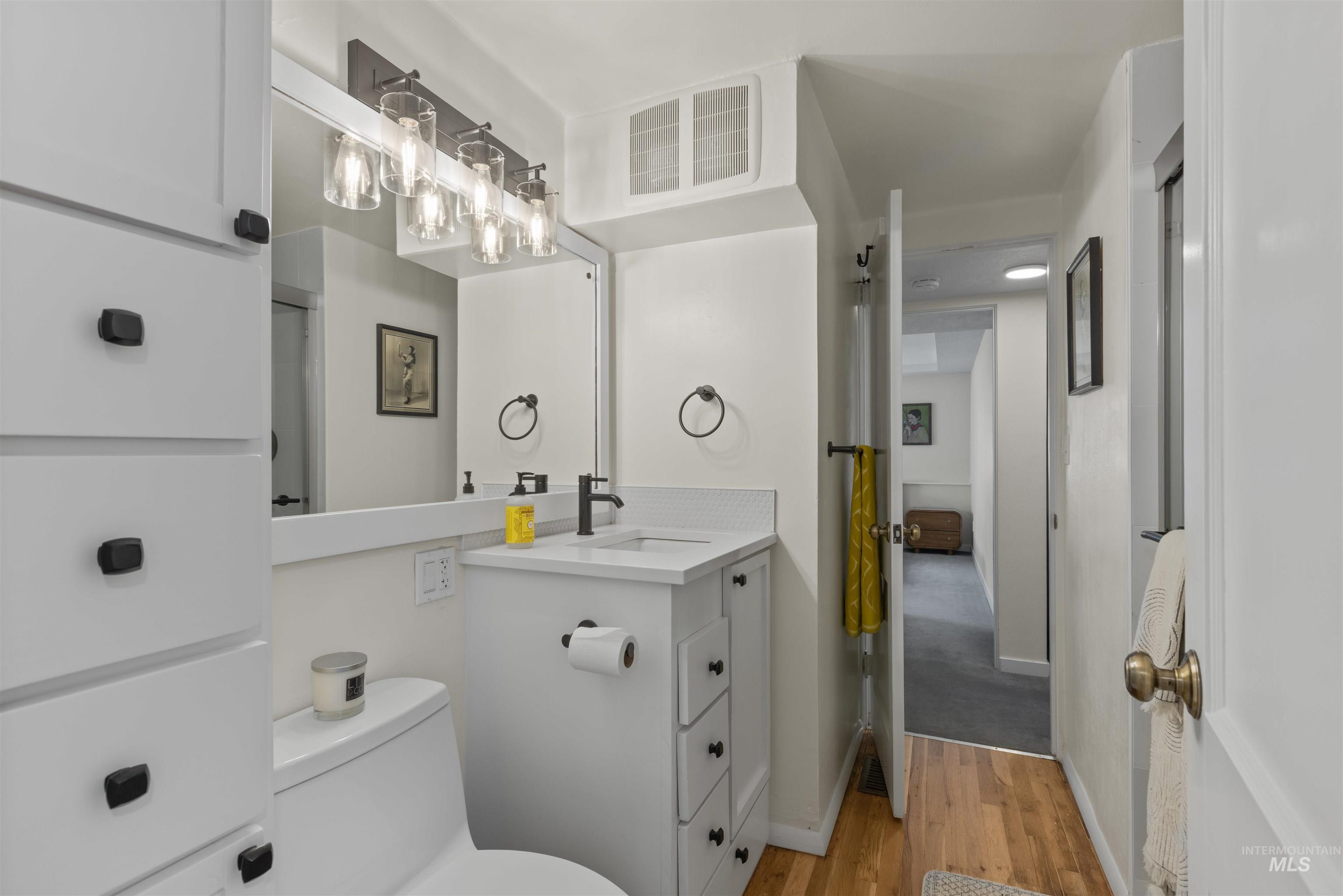 Bathroom with light wood-type flooring and vanity