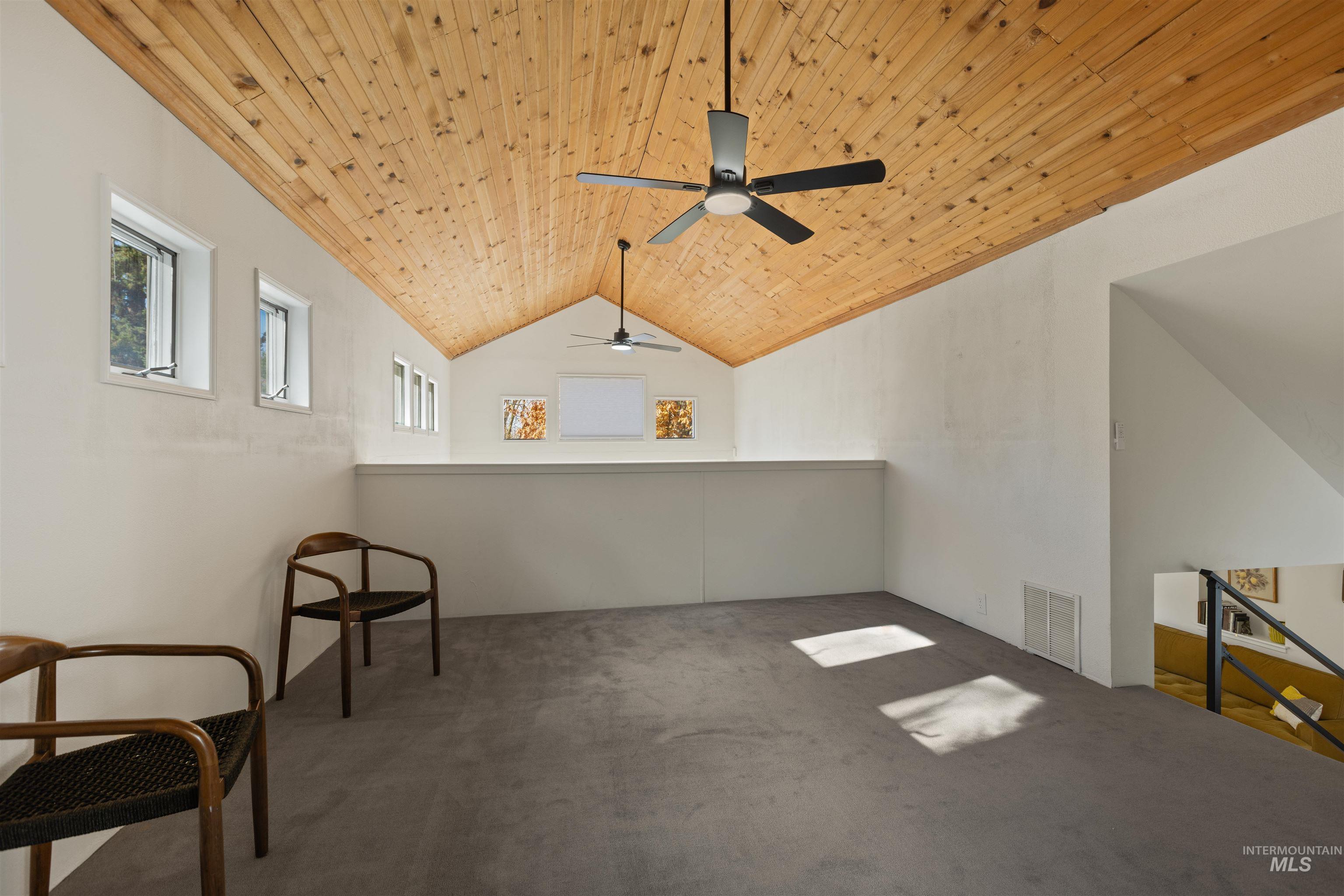 Additional living space with wood ceiling, carpet flooring, ceiling fan, and vaulted ceiling