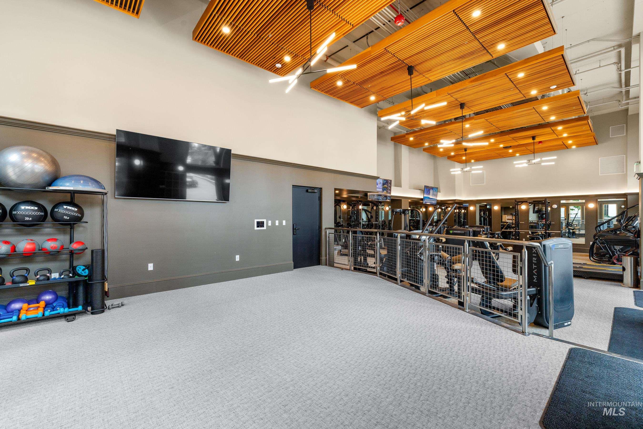 Interior space with carpet flooring and a high ceiling