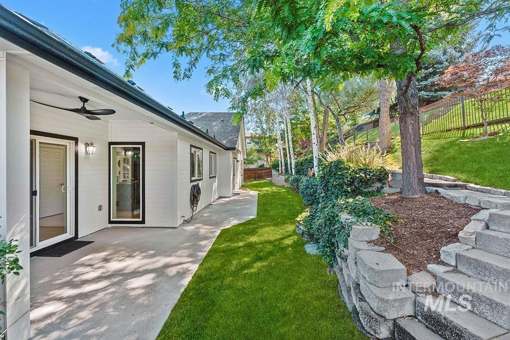 Fenced backyard featuring ceiling fan and a patio area
