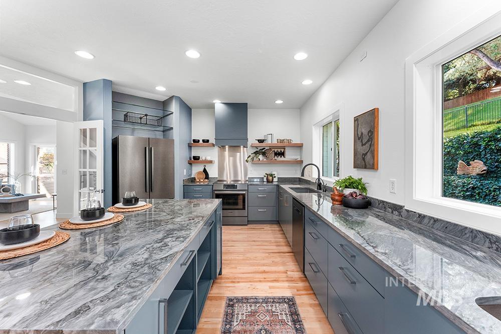 Kitchen featuring appliances with stainless steel finishes, open shelves, gray cabinetry, plenty of natural light, and recessed lighting