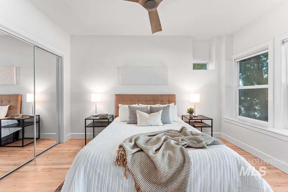Bedroom featuring wood finished floors, a closet, and ceiling fan