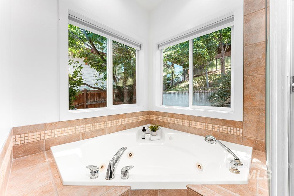 Full bathroom with a tub with jets