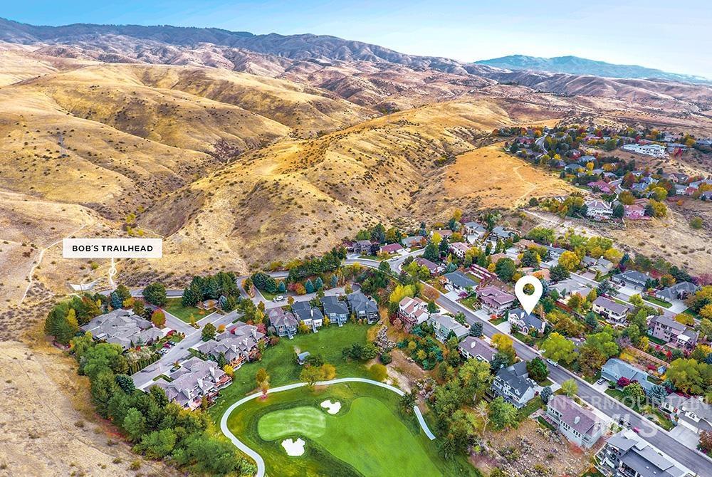 Aerial overview of property's location with mountains and nearby suburban area