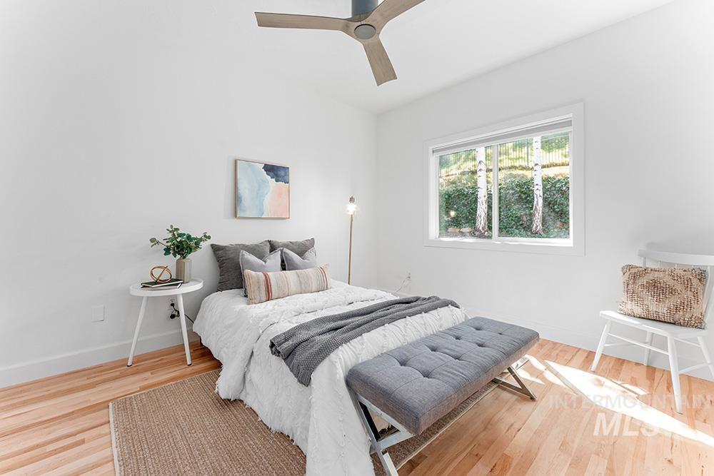 Bedroom featuring wood finished floors and a ceiling fan