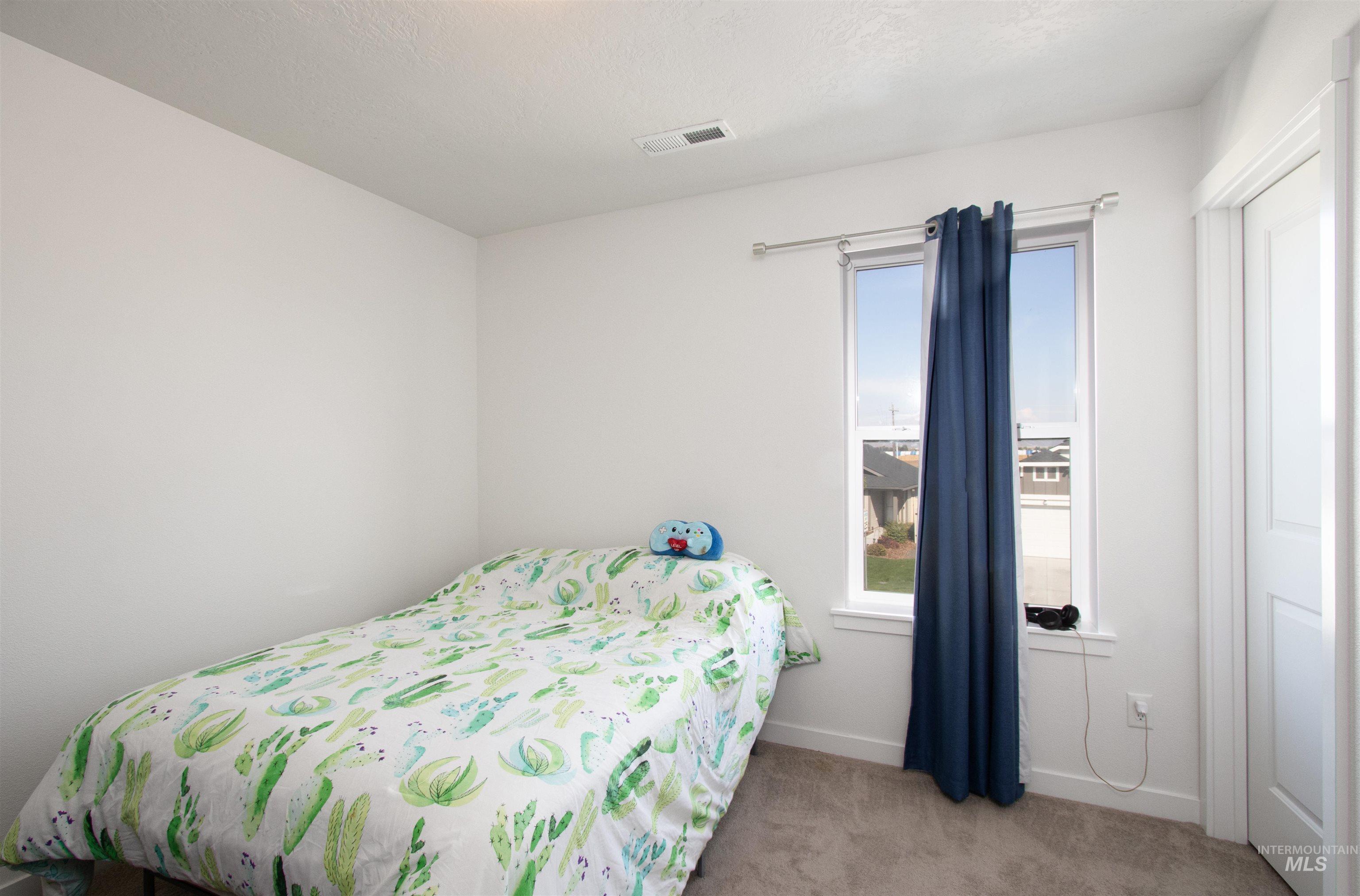 Carpeted bedroom with baseboards