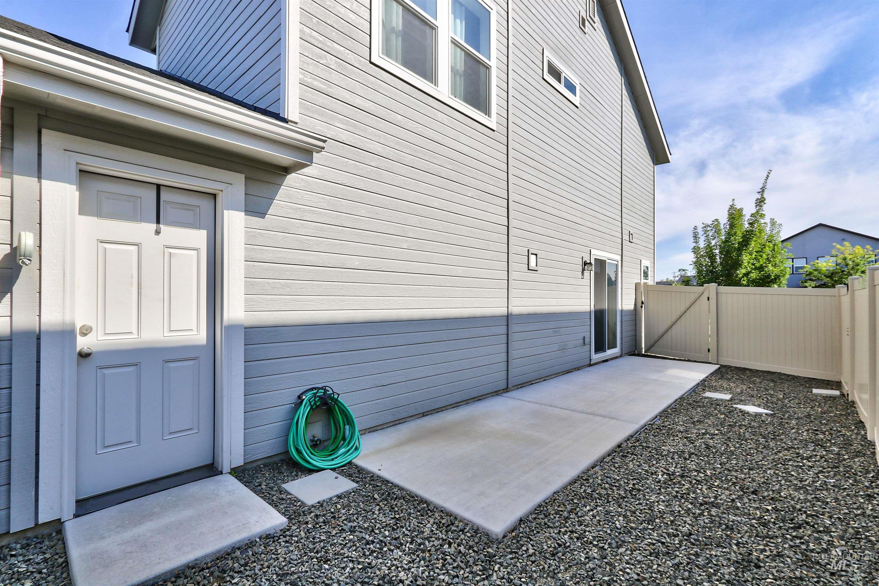 Doorway to property featuring a gate and a patio