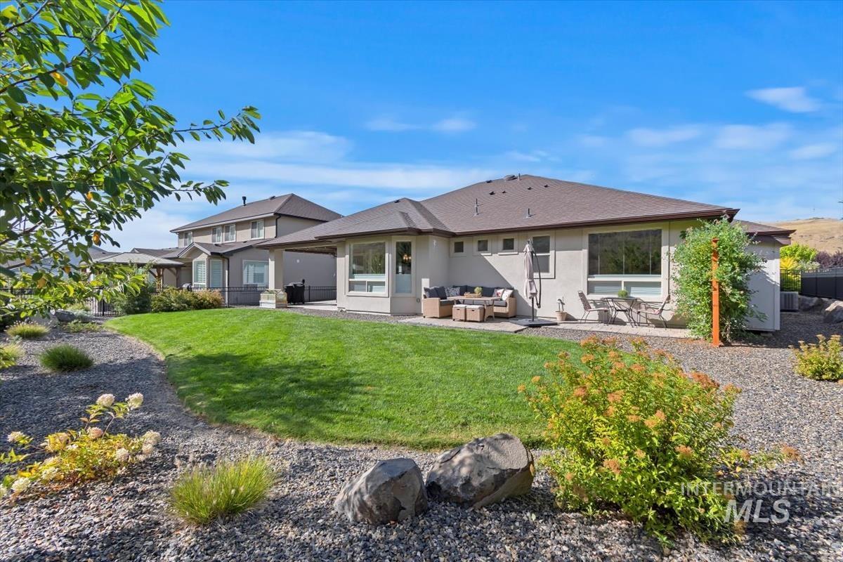 Back of property with a patio, stucco siding, and an outdoor living space