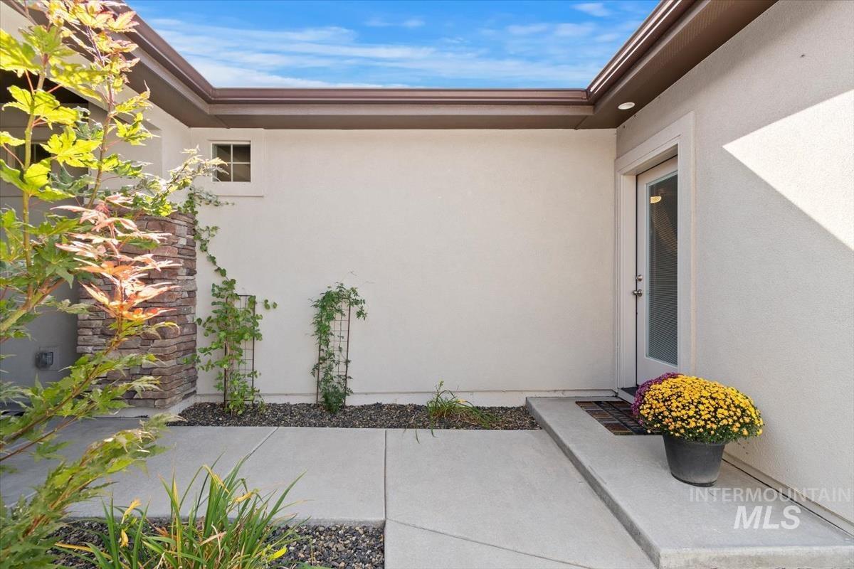 Entrance to property with stucco siding