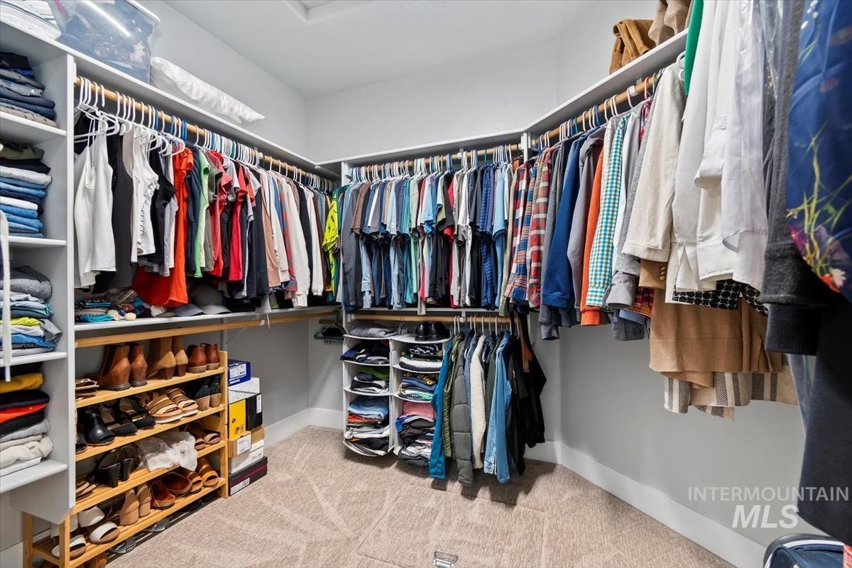 Walk in closet featuring light carpet