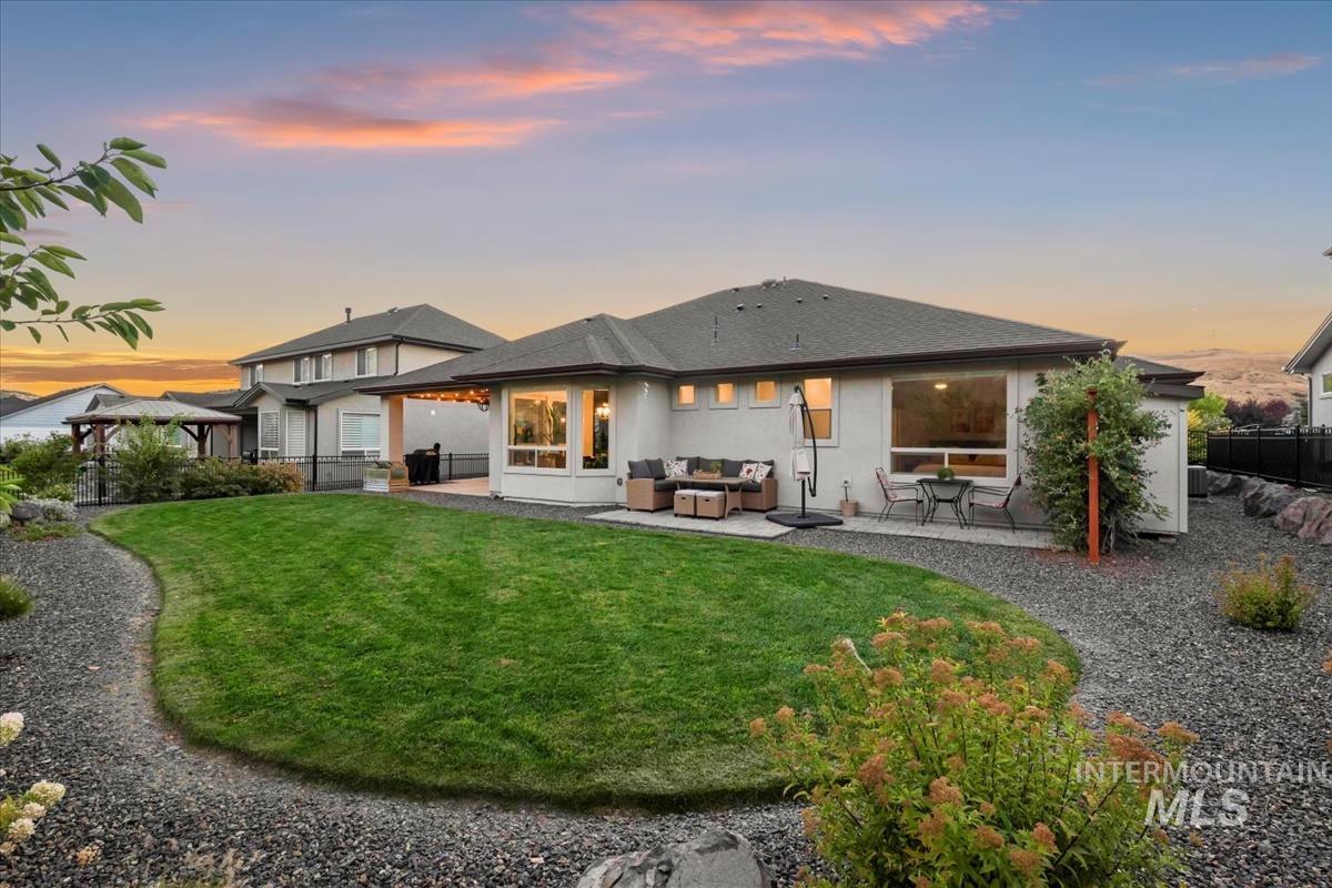Back of house with a patio, an outdoor hangout area, roof with shingles, and stucco siding