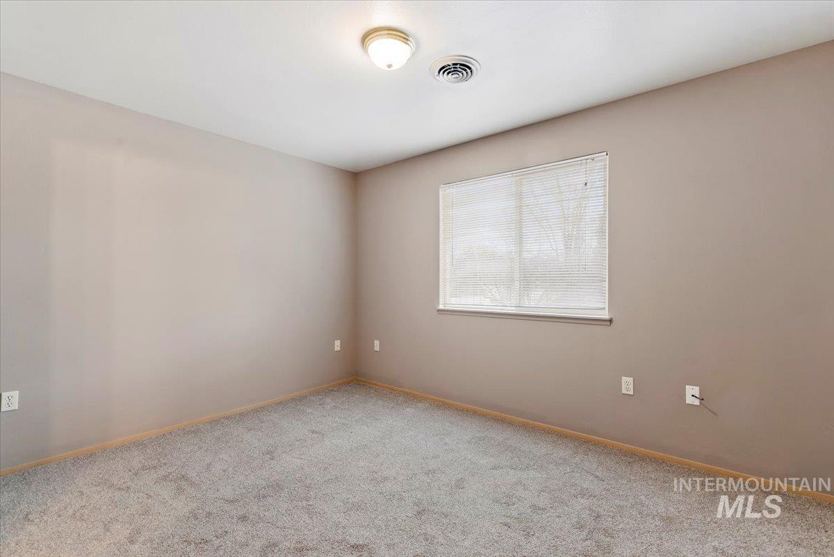 Unfurnished room with carpet floors and baseboards