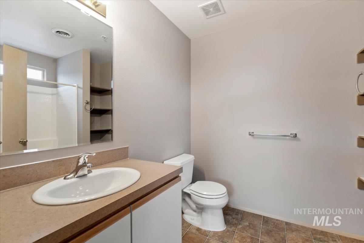 Bathroom featuring vanity and a shower
