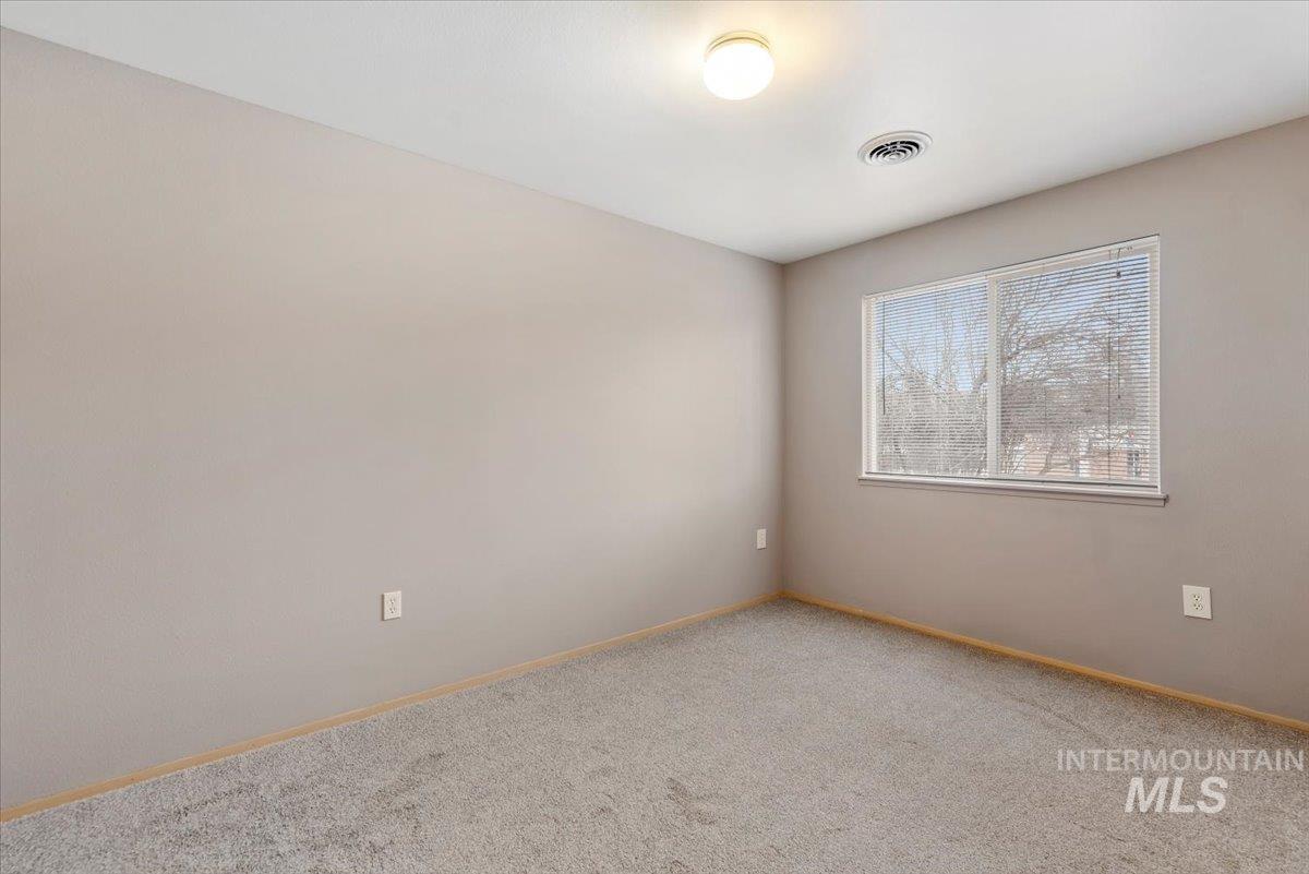 Empty room with carpet floors and baseboards