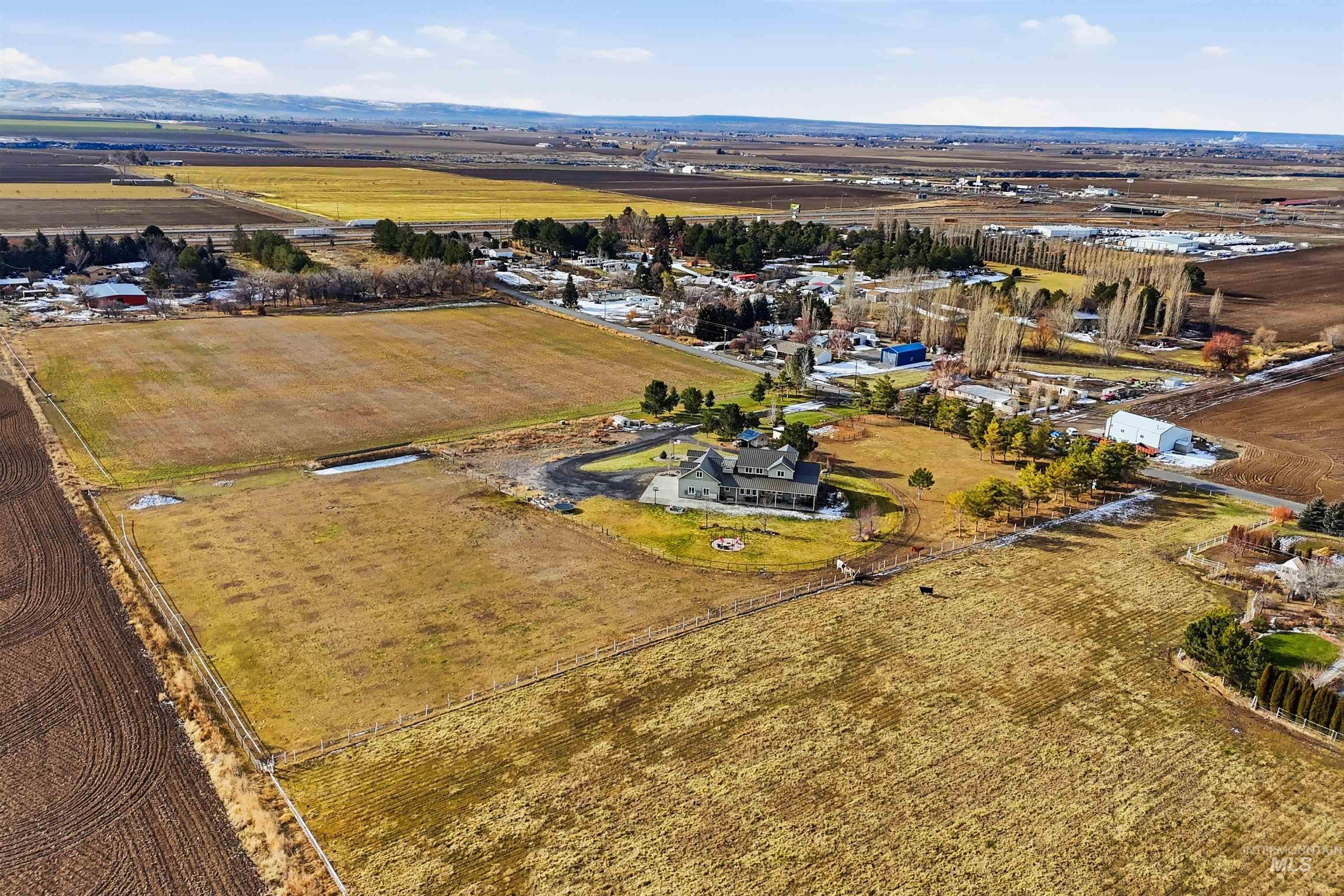 Aerial view of sparsely populated area with large plots for crops