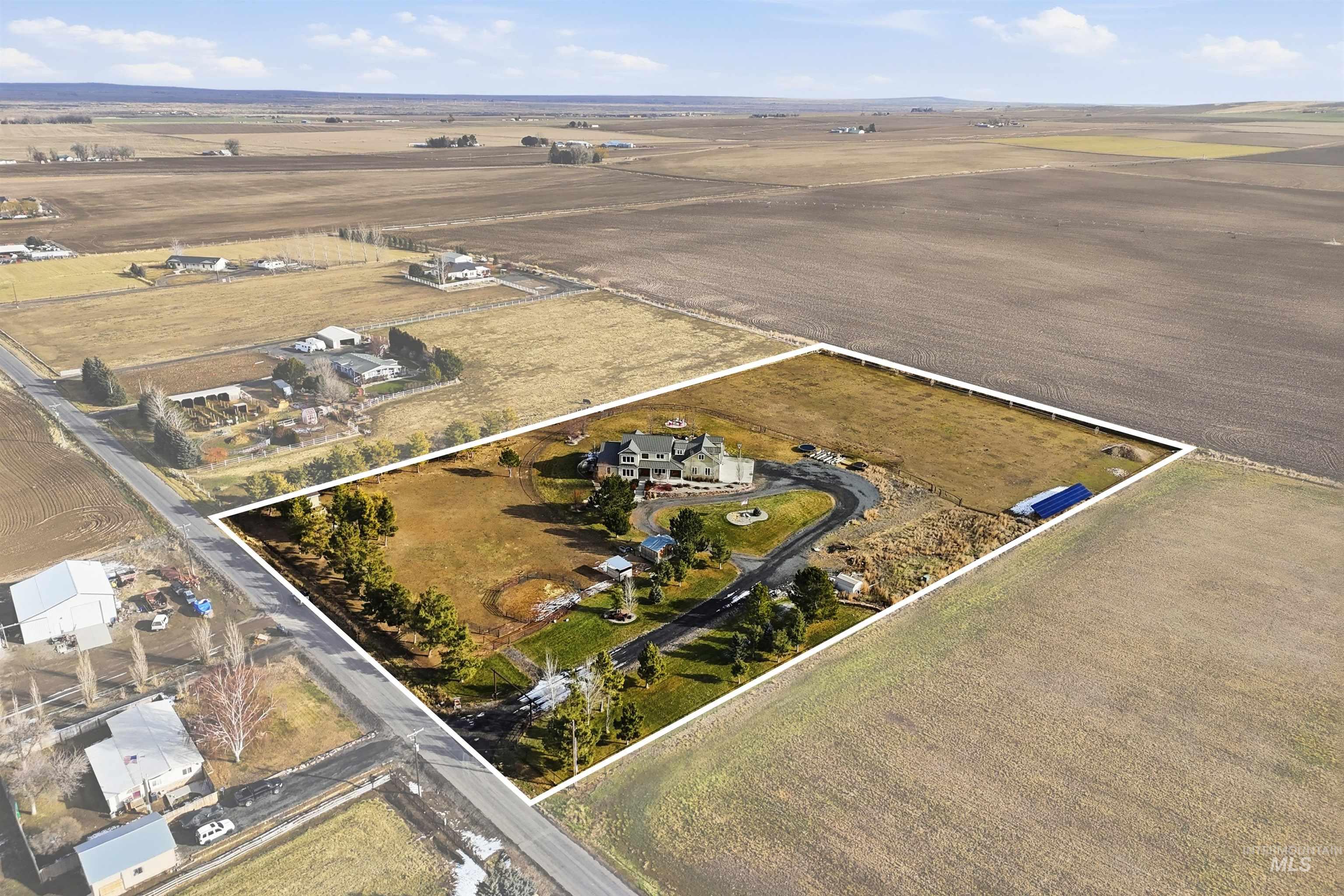 Aerial view of property and surrounding area featuring rural landscape and property parcel outlined