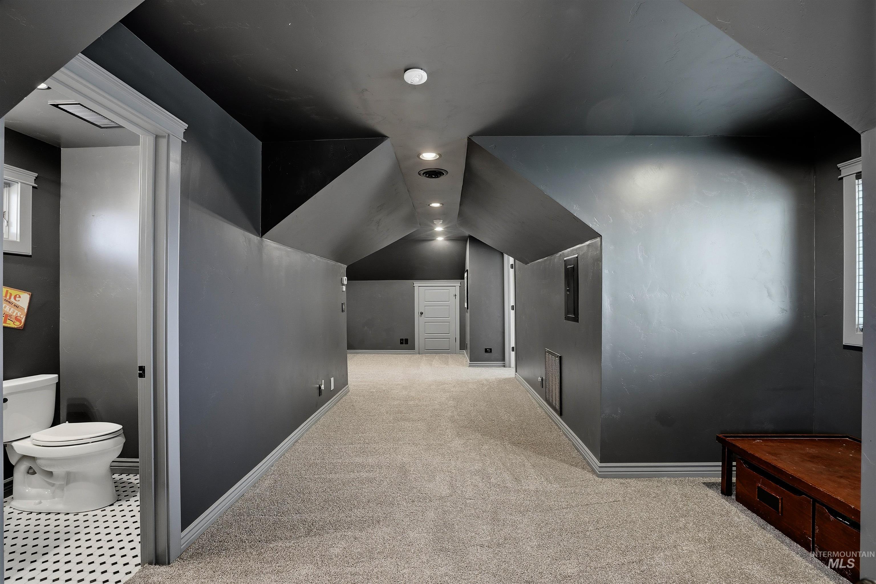 Cinema room featuring vaulted ceiling, light colored carpet, and recessed lighting