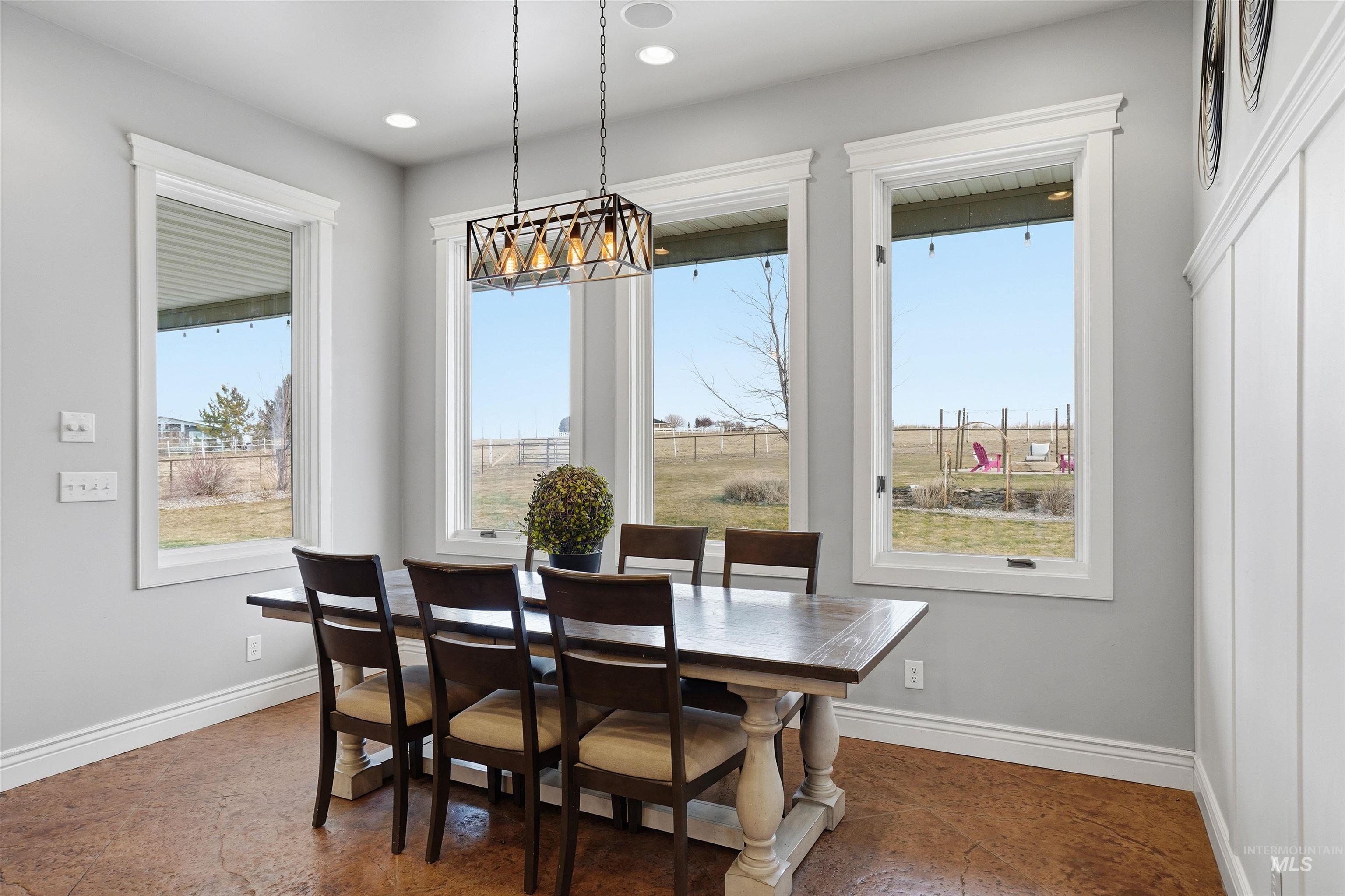 Dining area with baseboards and recessed lighting