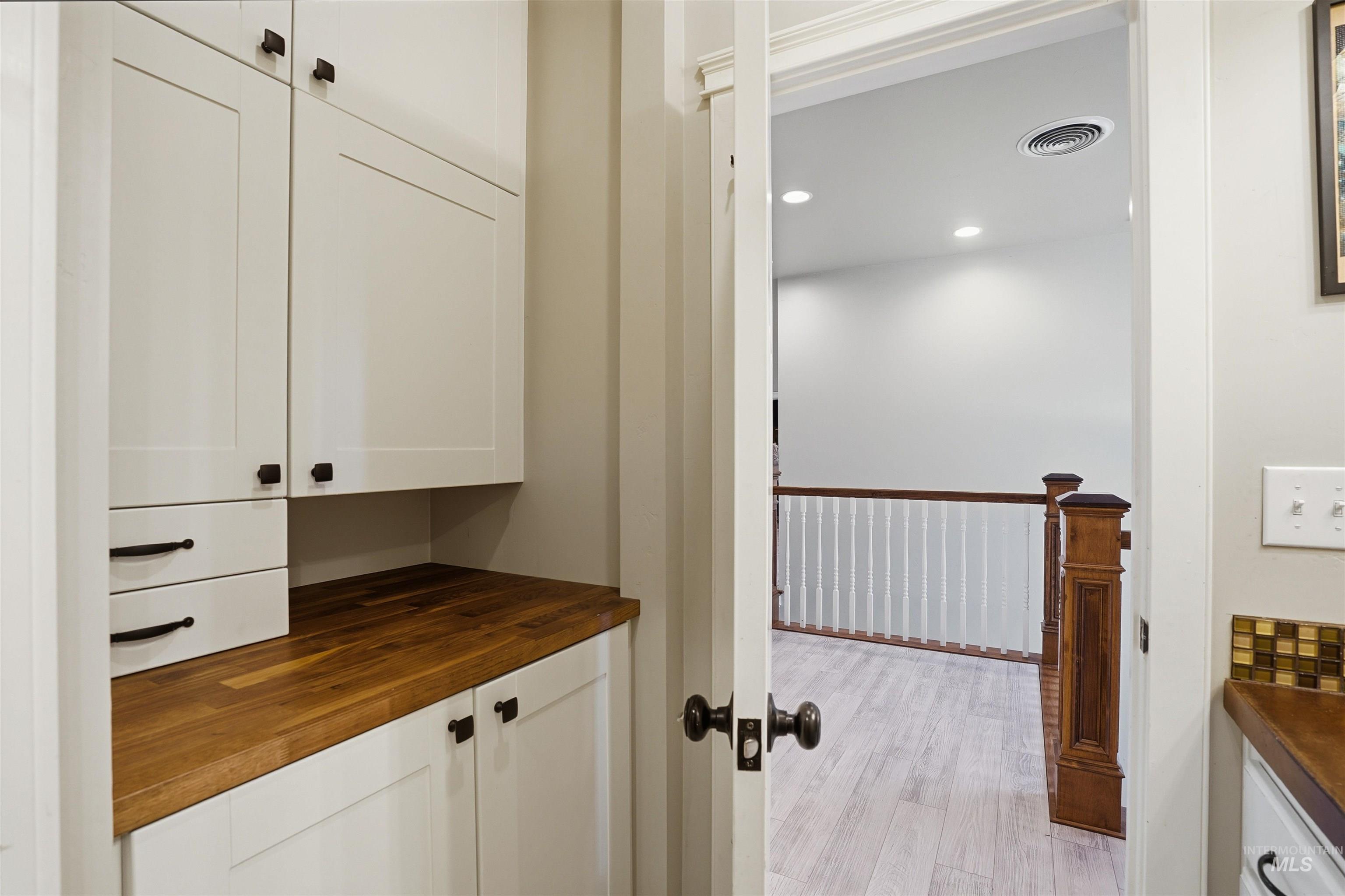 Detailed view of recessed lighting and wood finished floors
