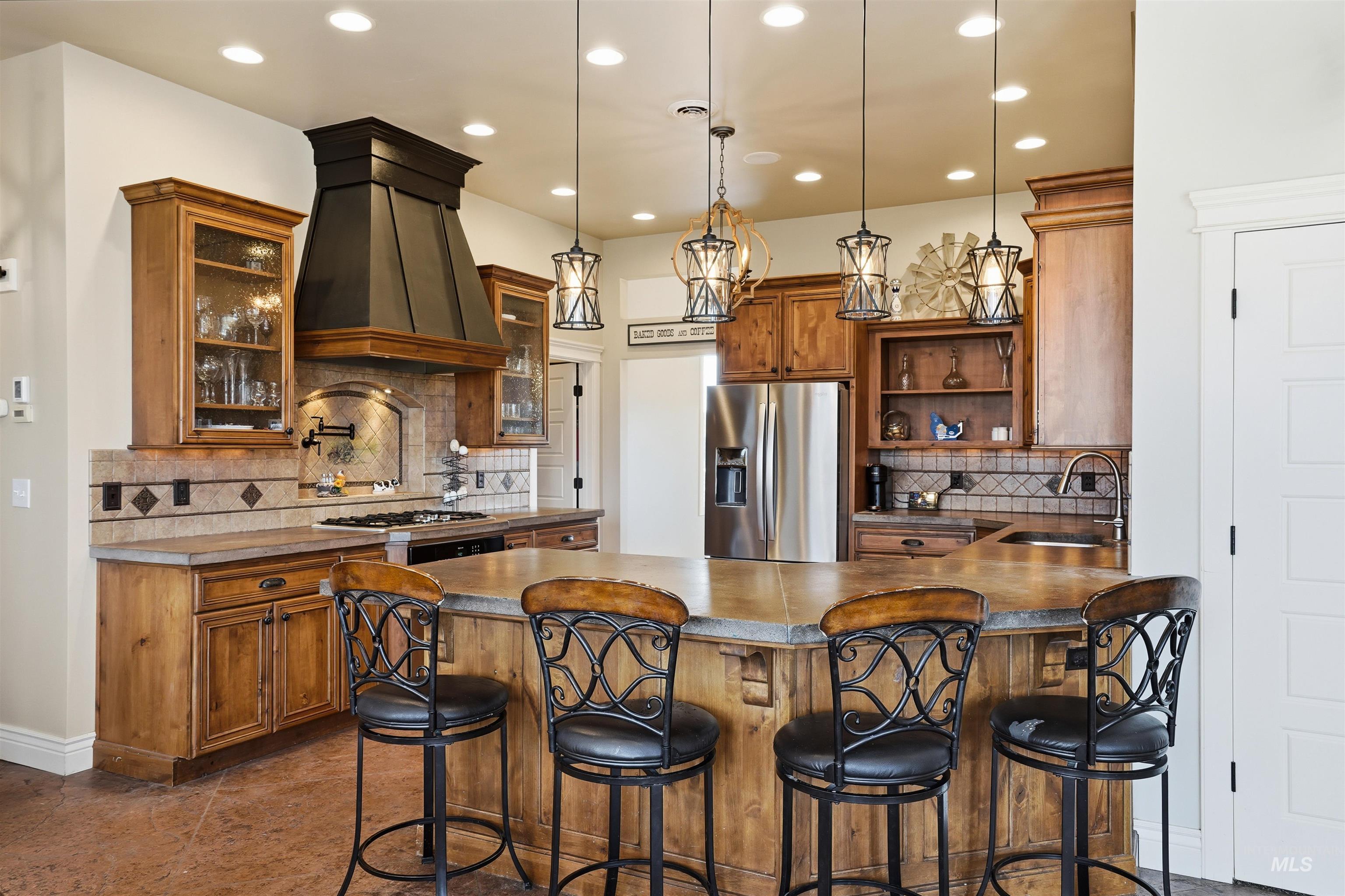 Kitchen featuring open shelves, a breakfast bar area, wood finish cabinets, and a peninsula