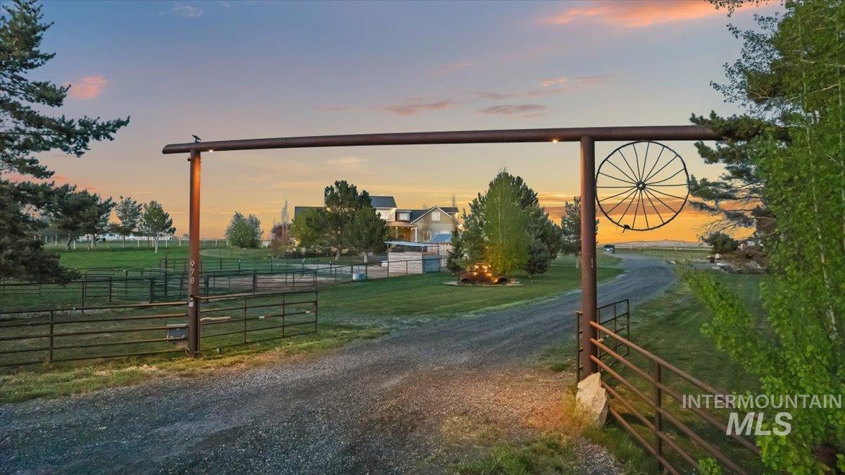 View of dirt / gravel road with a gated entry and a view of countryside